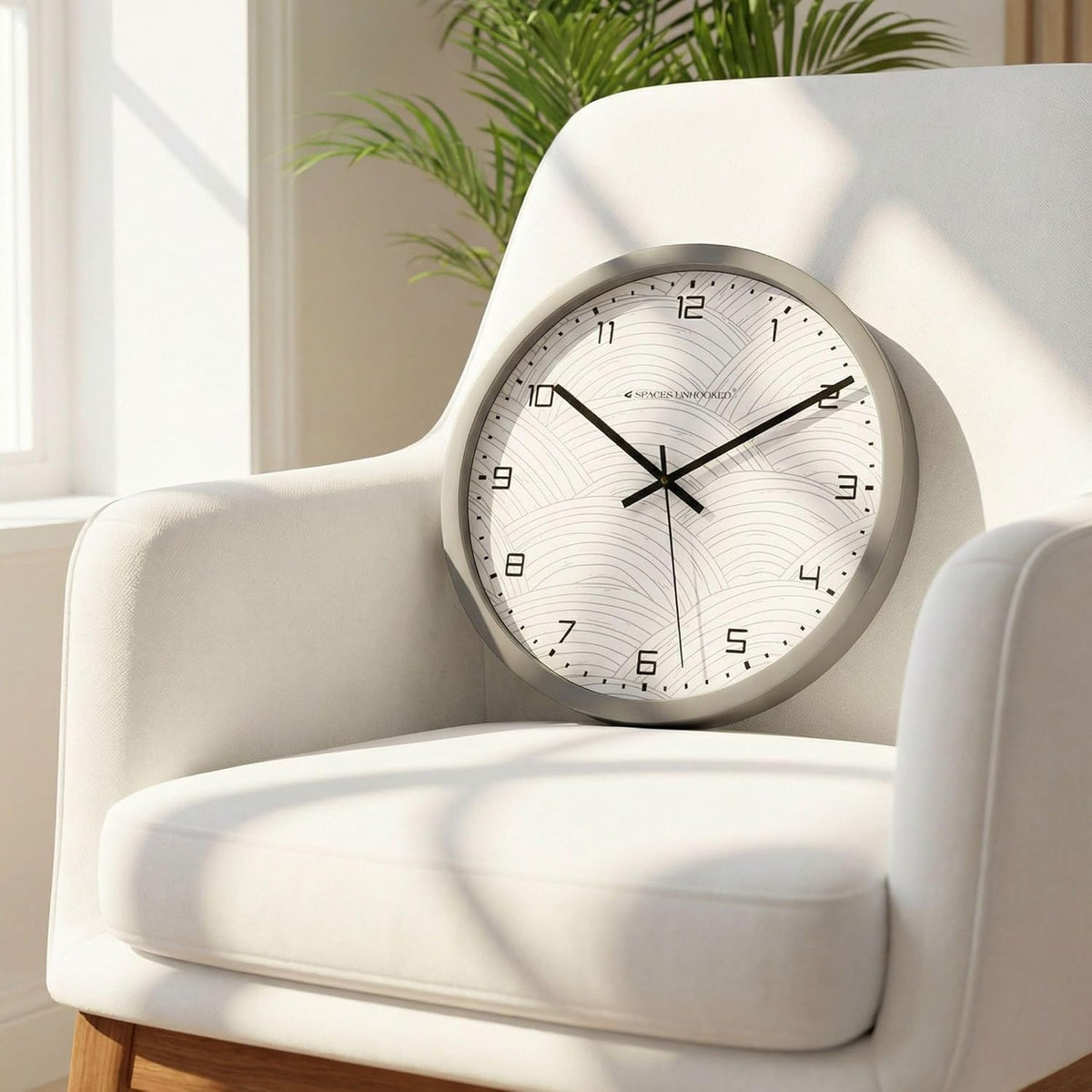 Round wall clock on a white armchair with a plant in the background