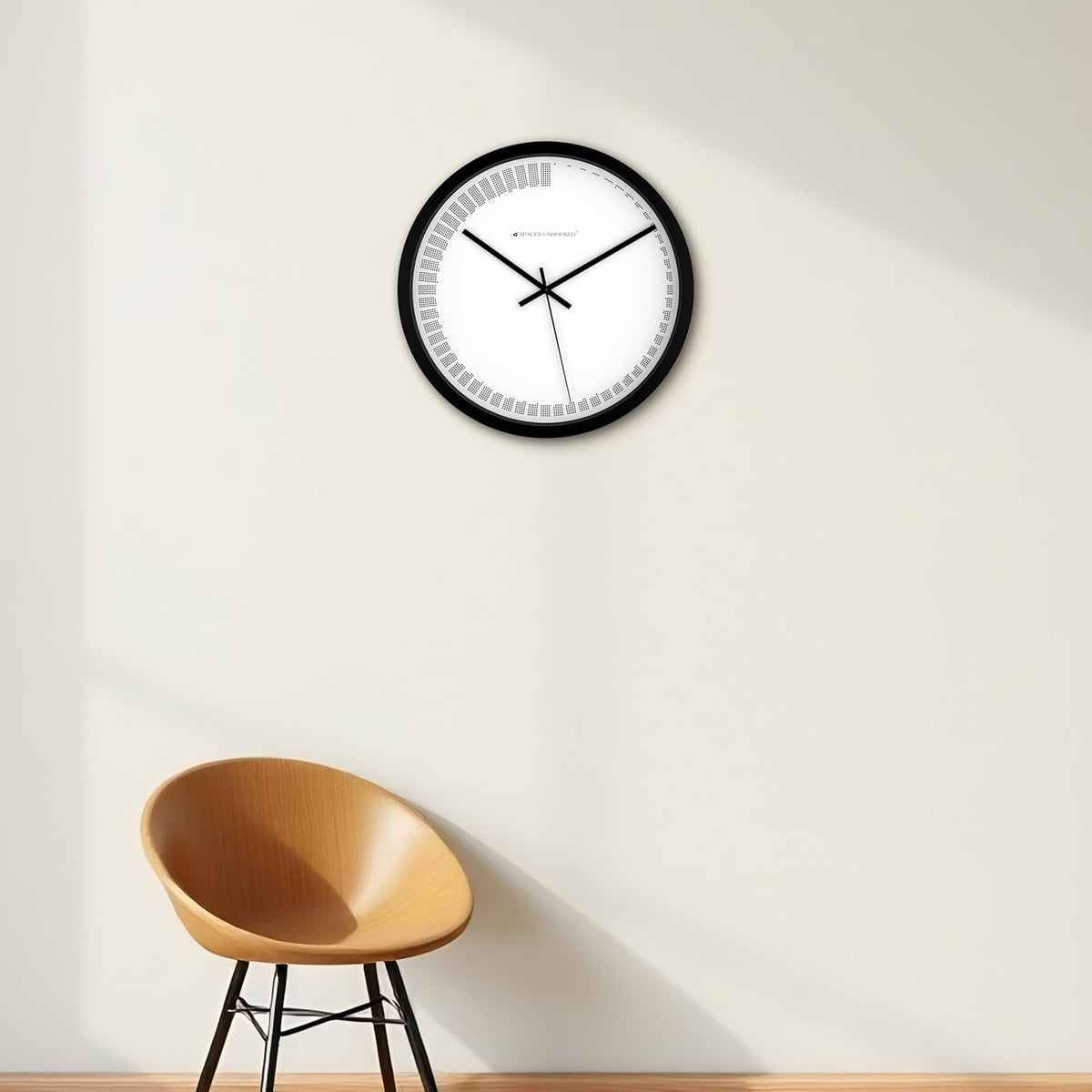 Wall clock on a white wall with a wooden chair in the foreground