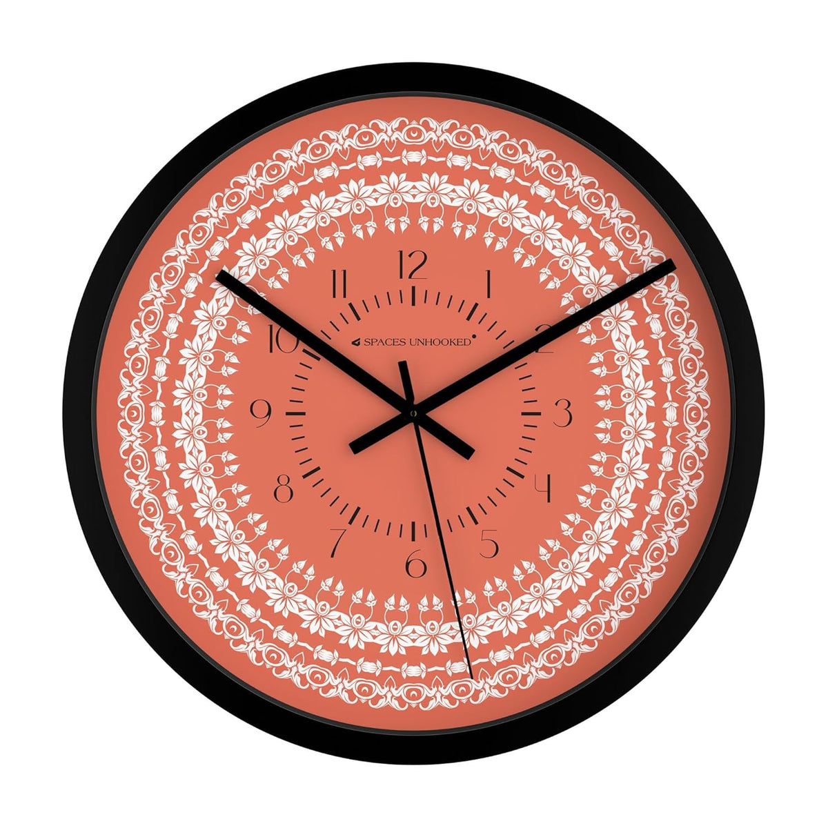 Decorative orange wall clock with intricate white floral mandala pattern and black frame