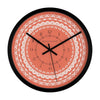 Decorative orange wall clock with intricate white floral mandala pattern and black frame