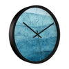 Abstract art wall clock with layered blue tones and minimalist hands