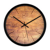 Rustic wooden wall clock with engraved Roman numerals and black metal frame