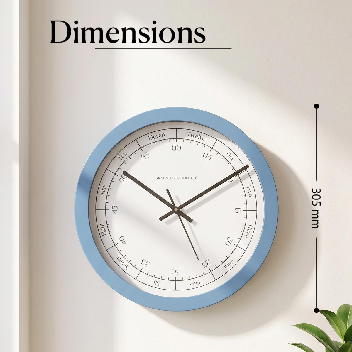 Blue and white wall clock in a coastal living room with sandy tones, linen and wicker