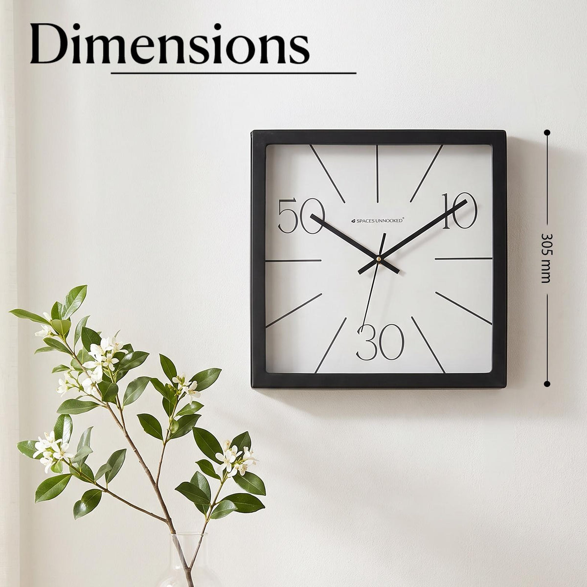 Close-up of radiating lines and light numerals 10, 30 and 50 on a white clock dial