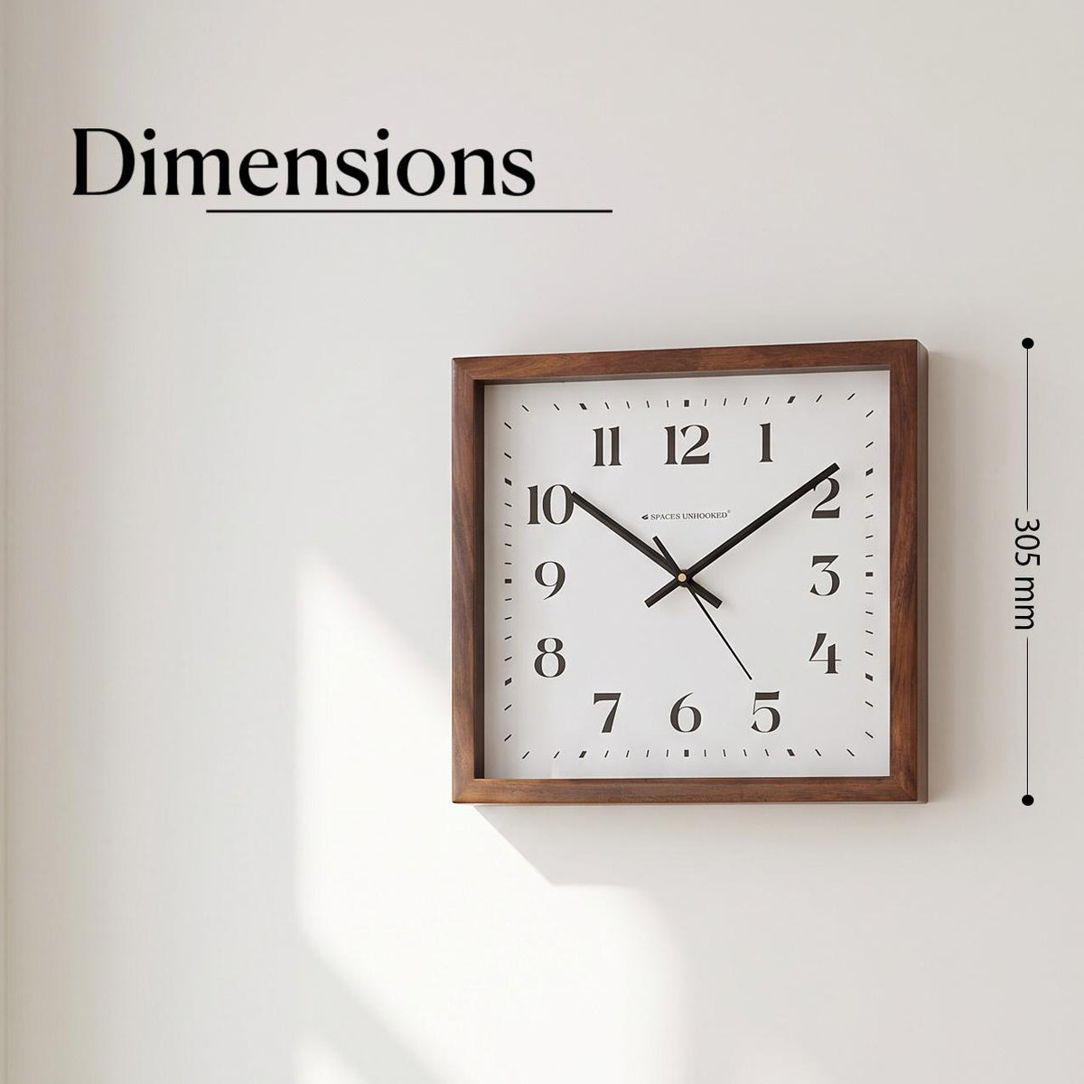 Close-up of bold black serif numerals 1 to 12 on the white dial of a square wooden wall clock