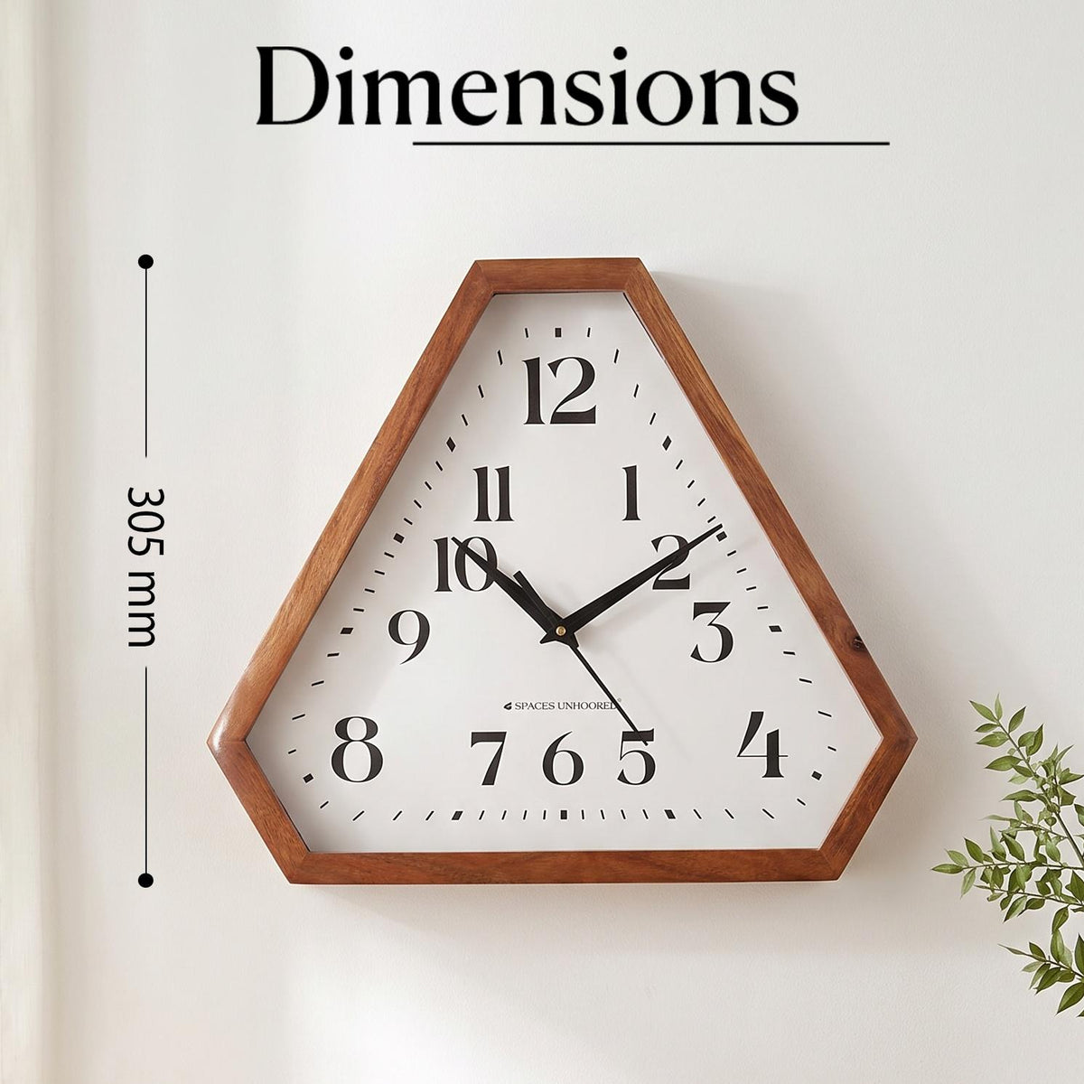 Close-up of bold black serif numerals 1 to 12 on the white dial of a triangular wall clock