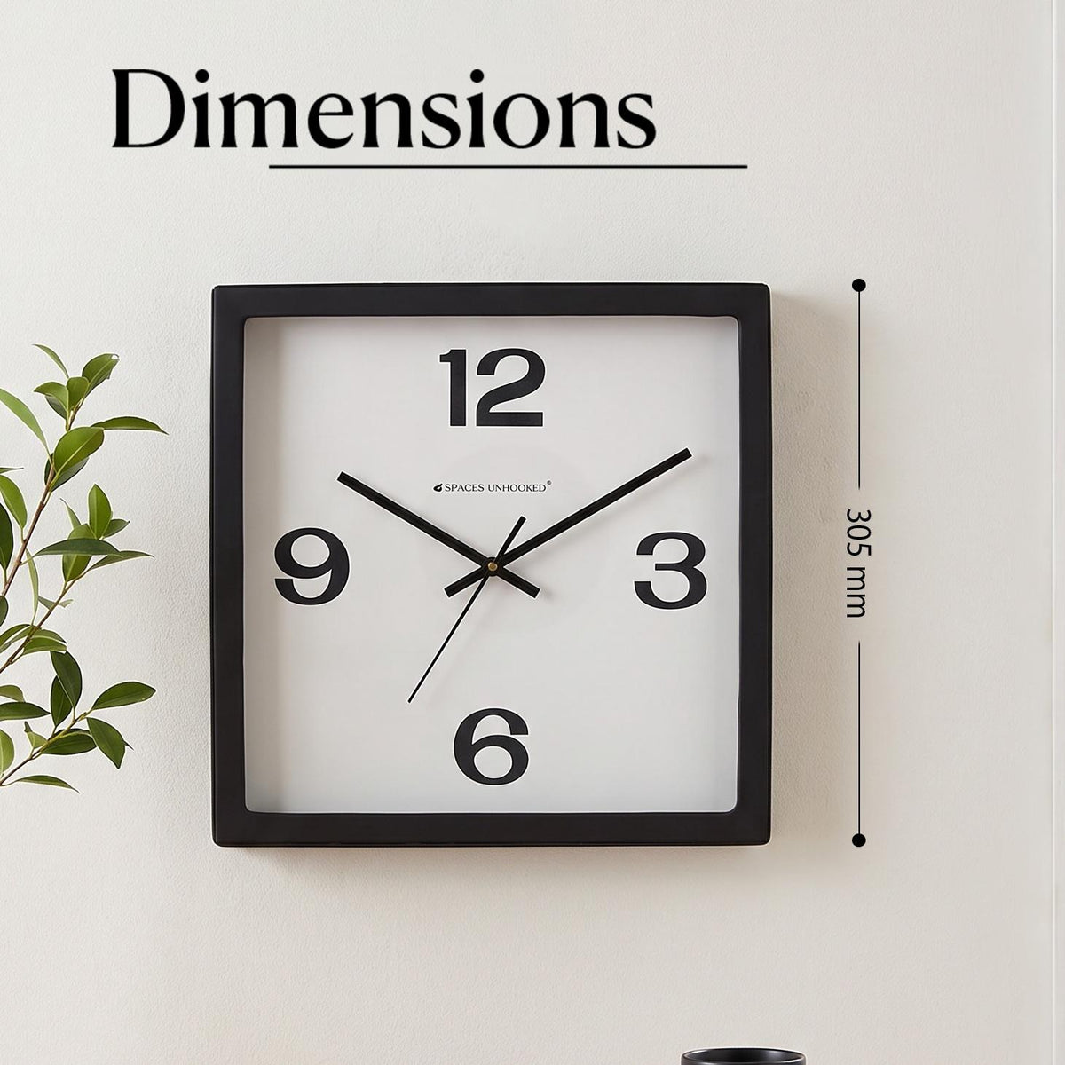 Close-up of heavy numerals 12, 3, 6 and 9 on a plain white clock dial
