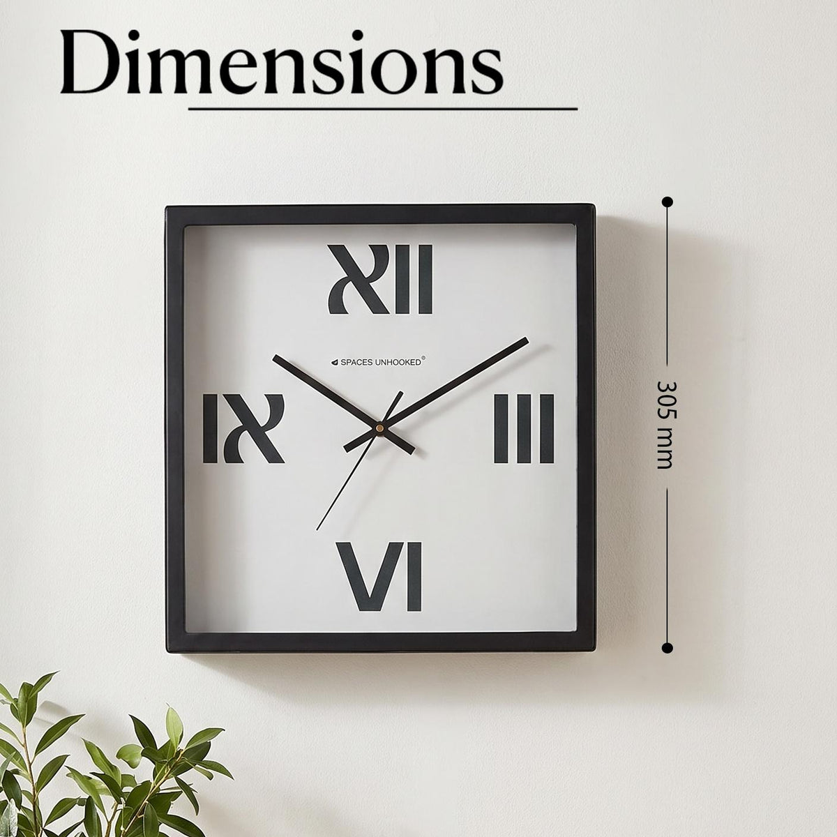 Close-up of bold Roman numerals XII, III, VI and IX on a plain white clock dial
