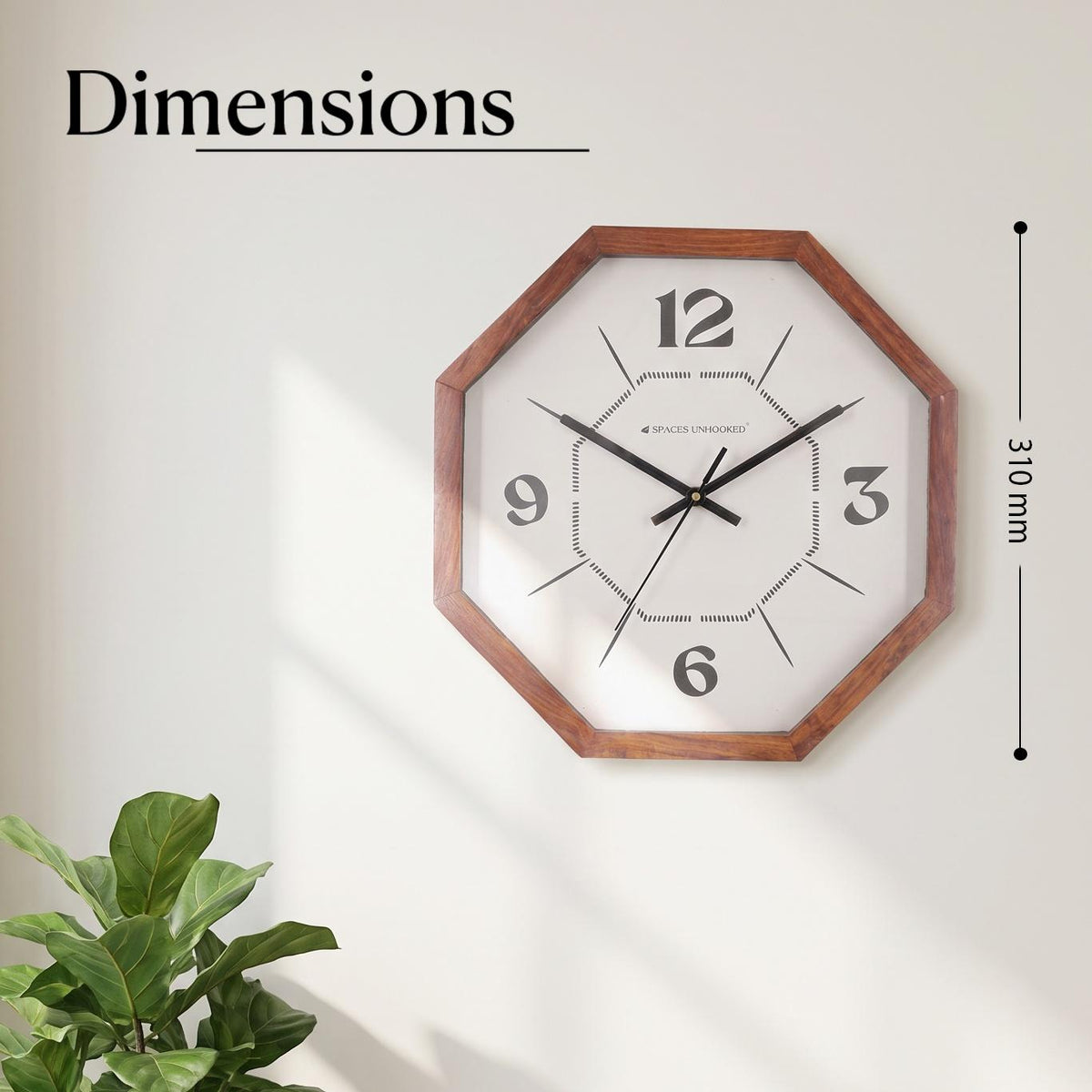 Close-up of bold 12, 3, 6 and 9 numerals on a white dial with a dotted inner octagon pattern