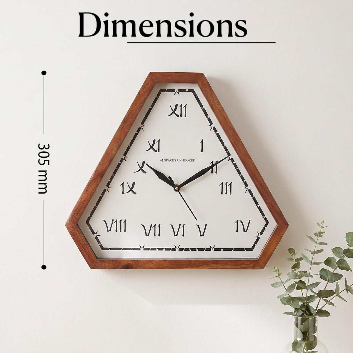 Close-up of hand-brushed style Roman numerals I to XII on a white triangular clock dial