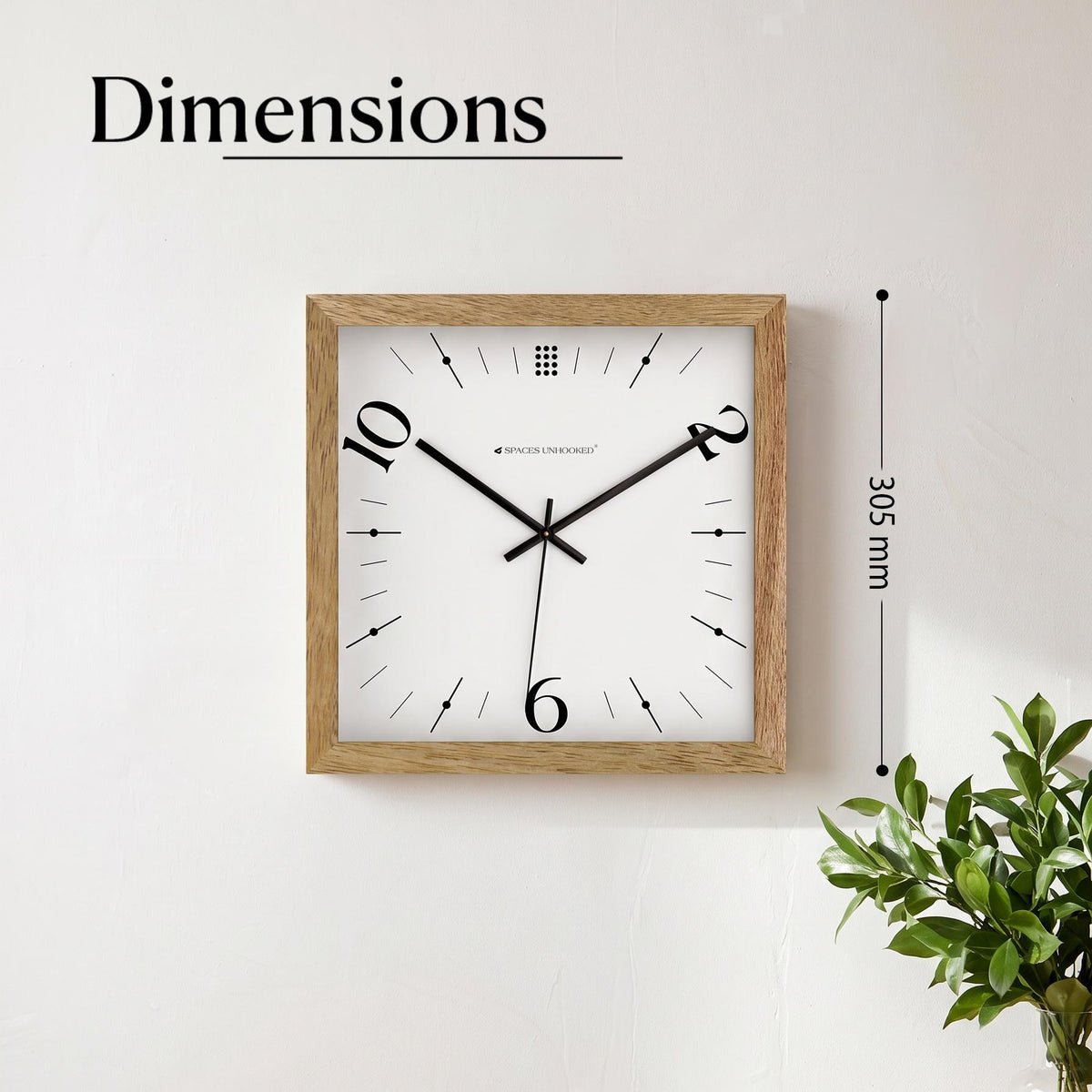 Playful minimal square wall clock over a console in a studio apartment with plants