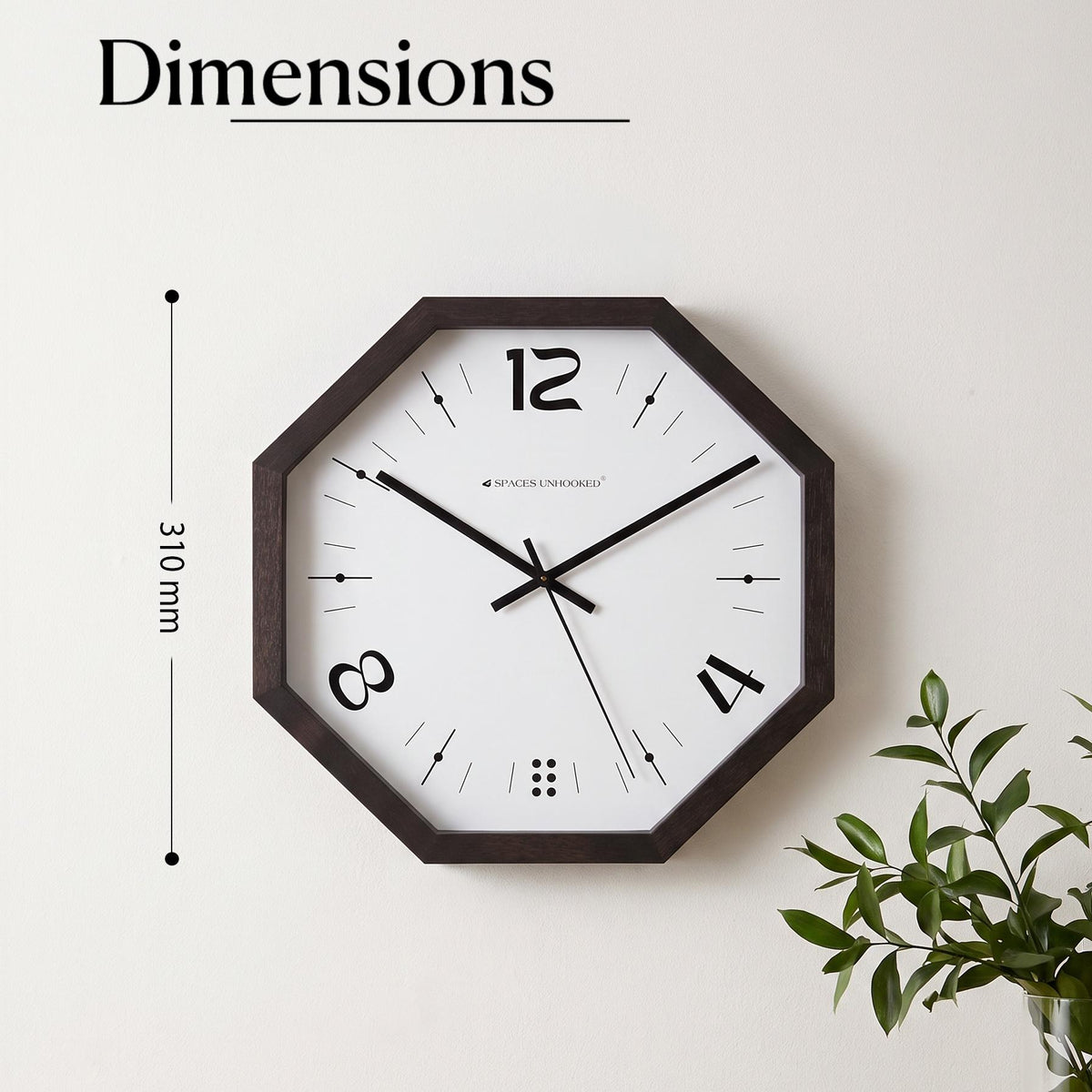 Black and white octagonal wall clock over a sofa in an industrial living room with concrete