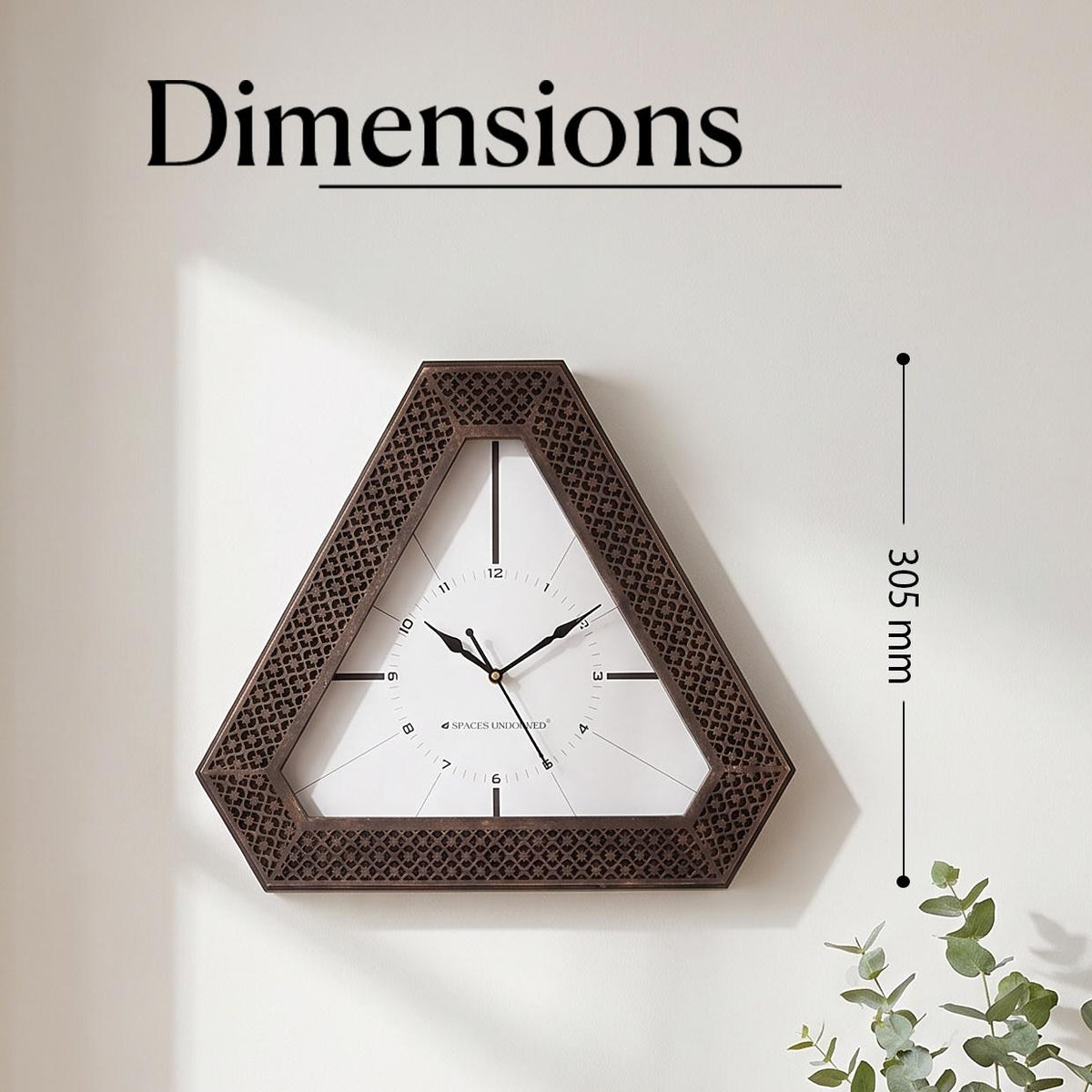 Triangular bronze wall clock on a hallway wall above a console