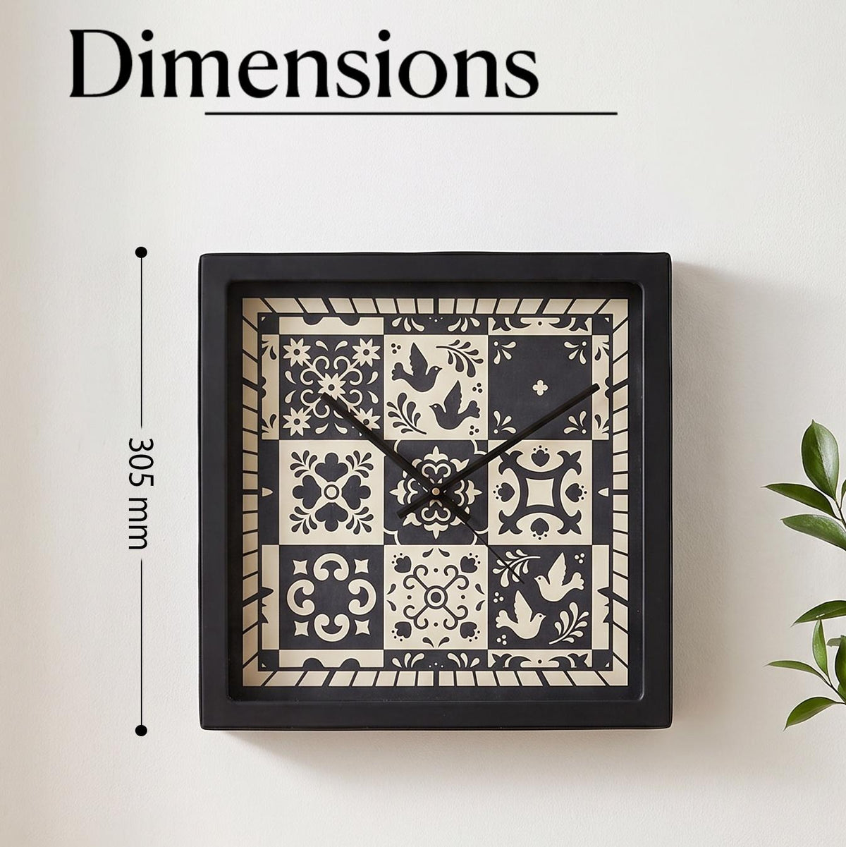 Close-up of birds and floral motifs in black and cream tiles on a folk art clock dial