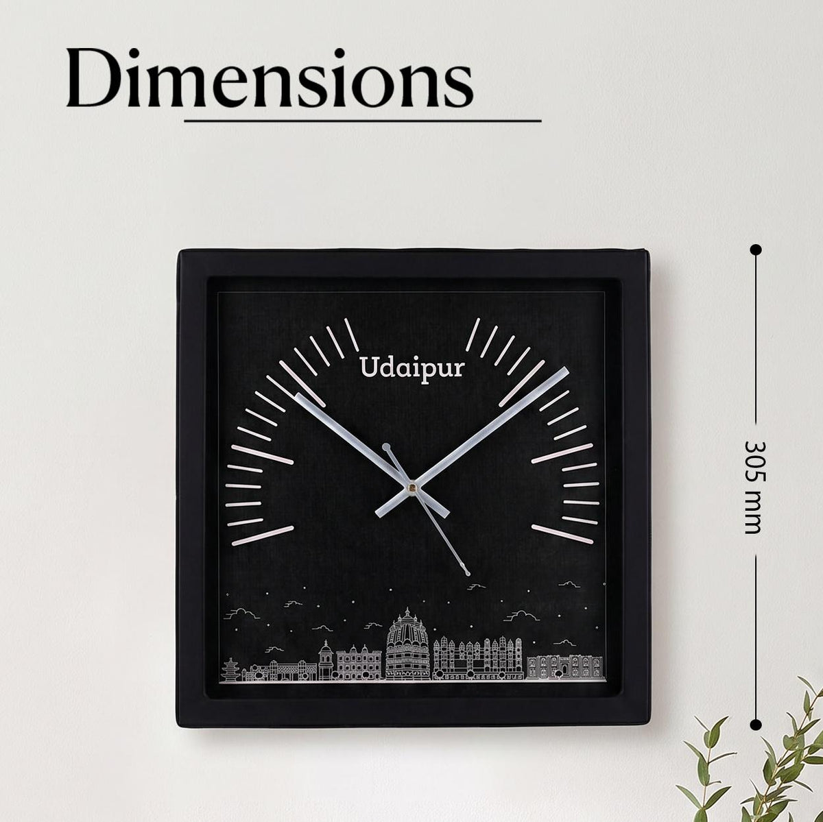Close-up of Udaipur skyline line art and name on a black clock dial