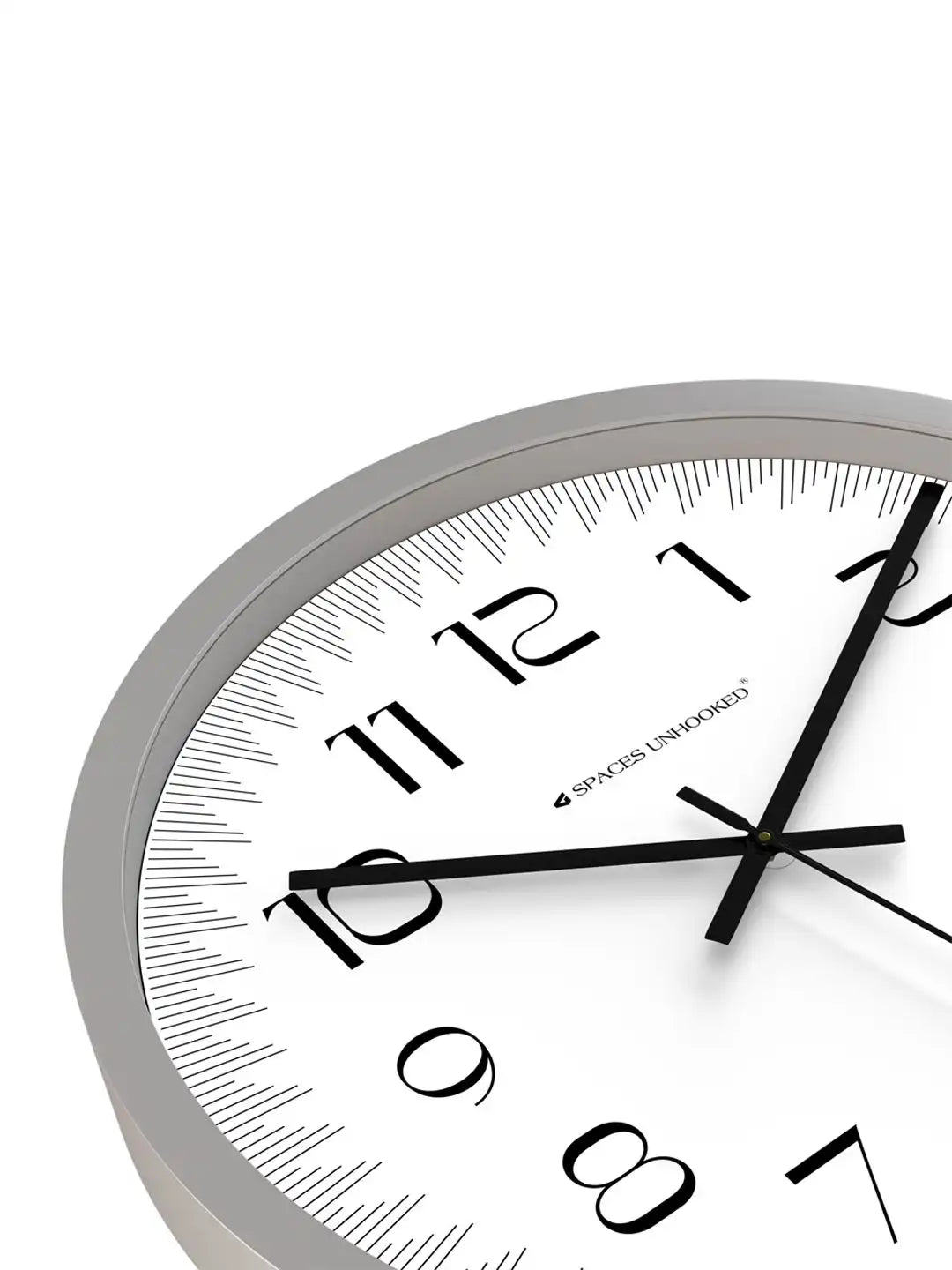Angled front view of Spaces Unhooked grey wall clock with white dial and bold Arabic numeral display