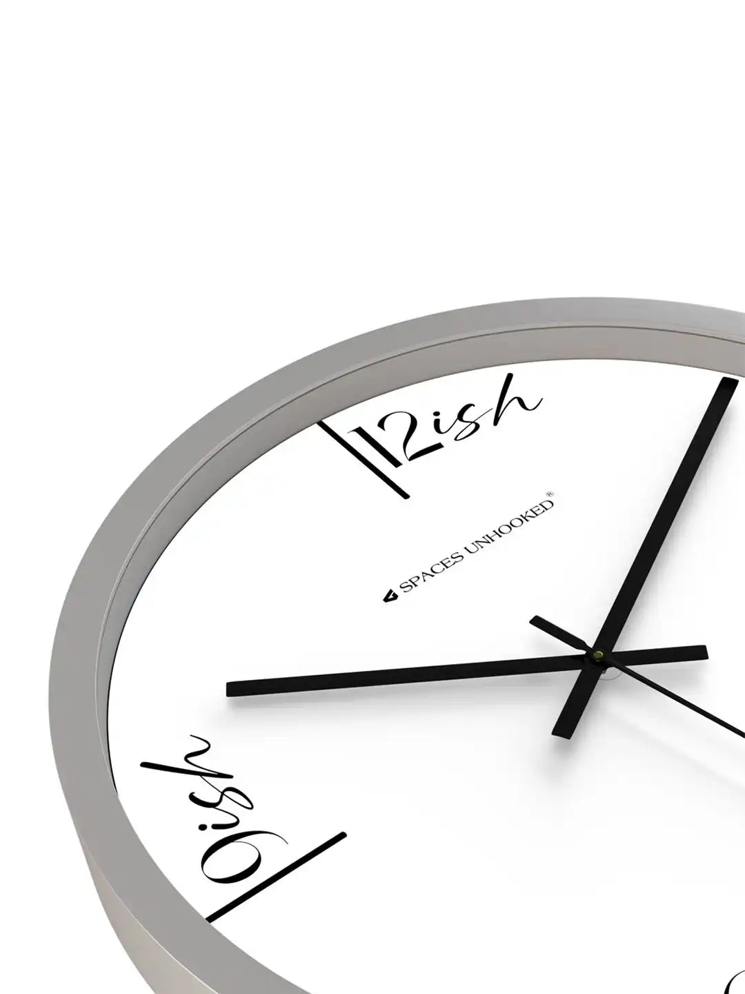 Close-up angled view of clock face showing "12ish" and "9ish" labels with crossed black hands against grey frame