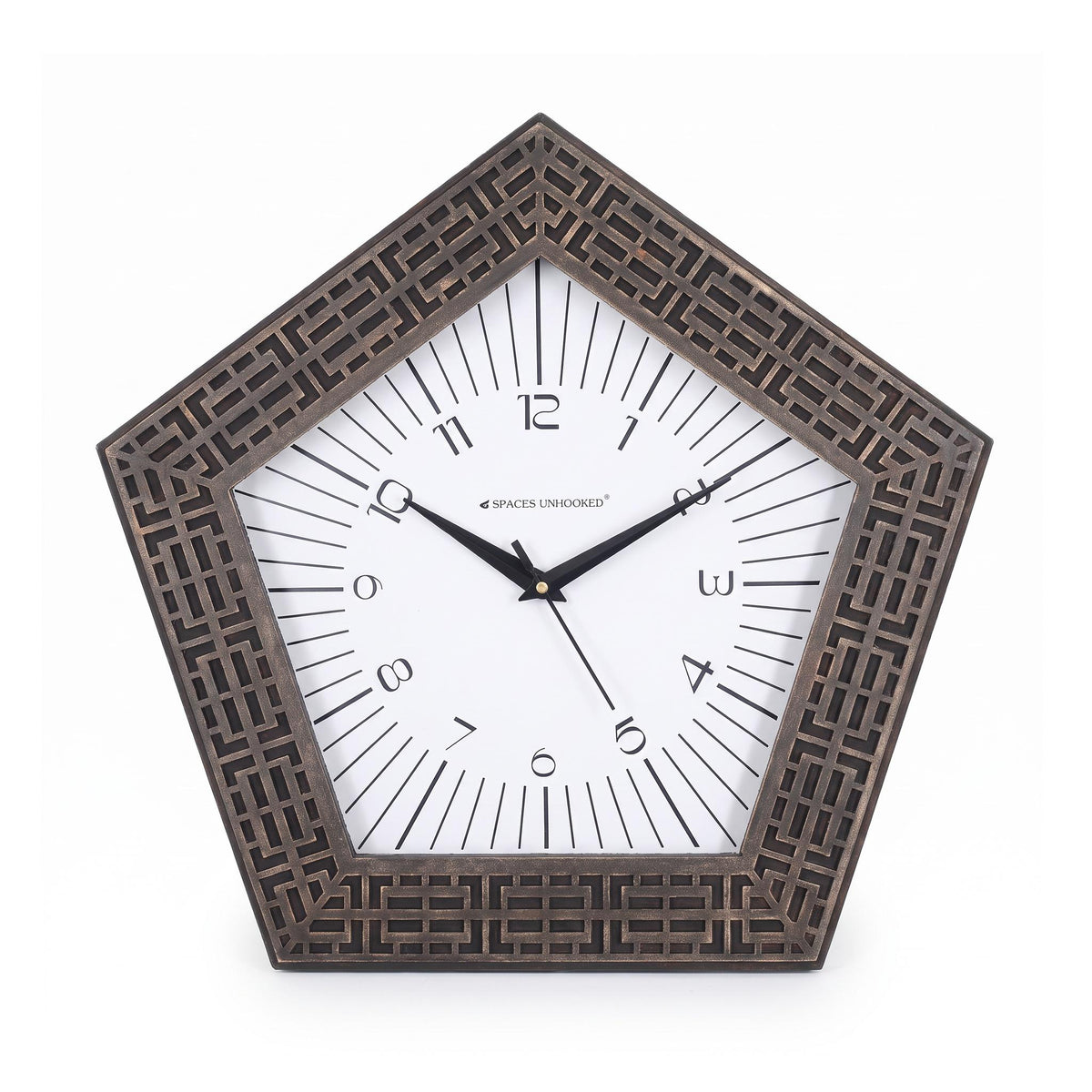 Pentagon bronze wall clock above a console in a bright hallway