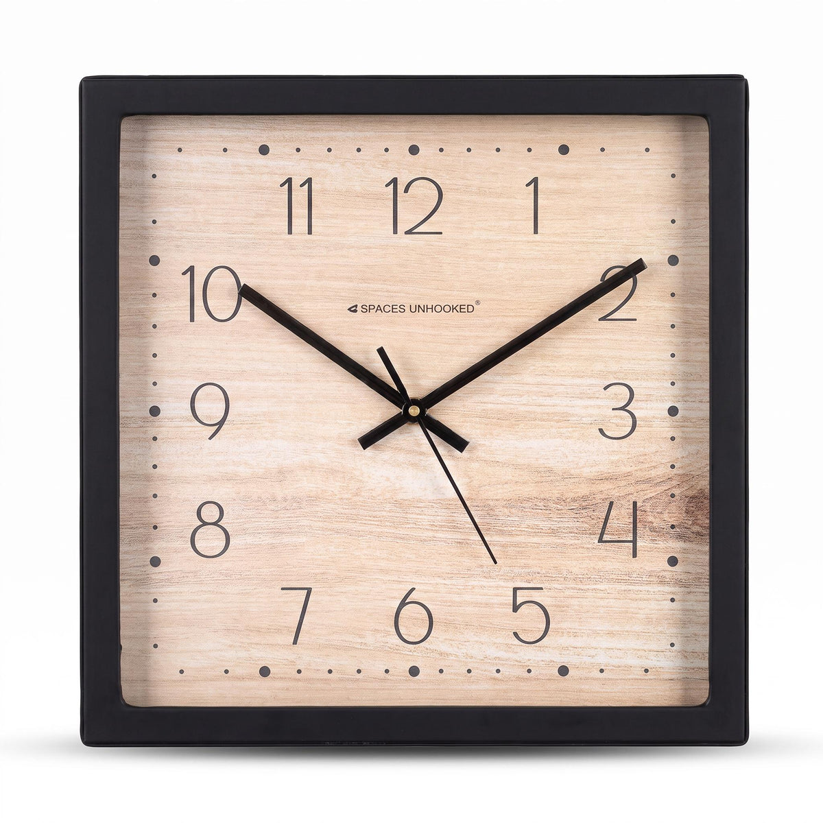 Wood-look dotted dial wall clock on a desk in a calm home office