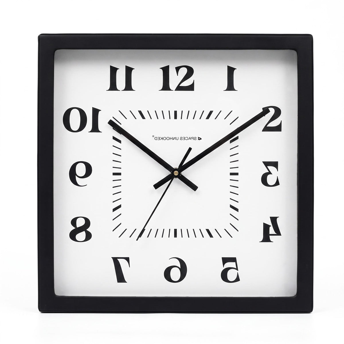 Mirror numerals wall clock on a desk in a creative studio