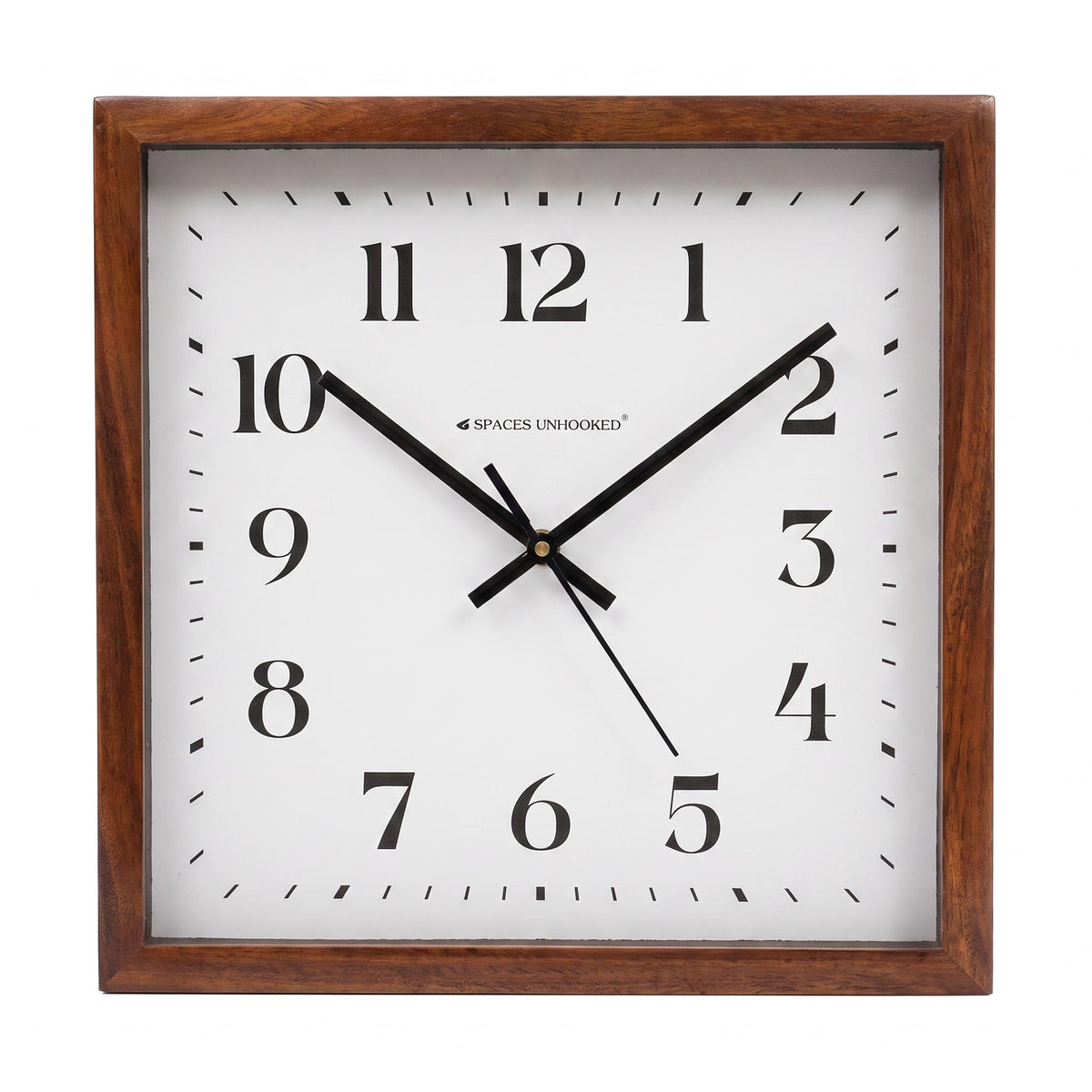 Classic square brown wall clock with white dial on a plain wall in a tidy home office