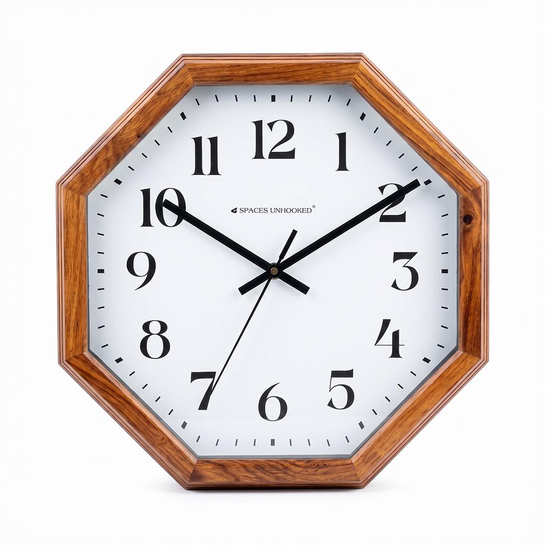 Bold serif octagon wall clock on a living room wall above a sofa