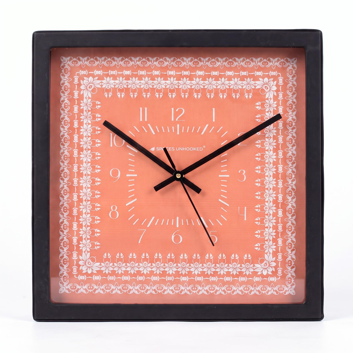 Coral floral border wall clock on a bedroom wall above a dresser