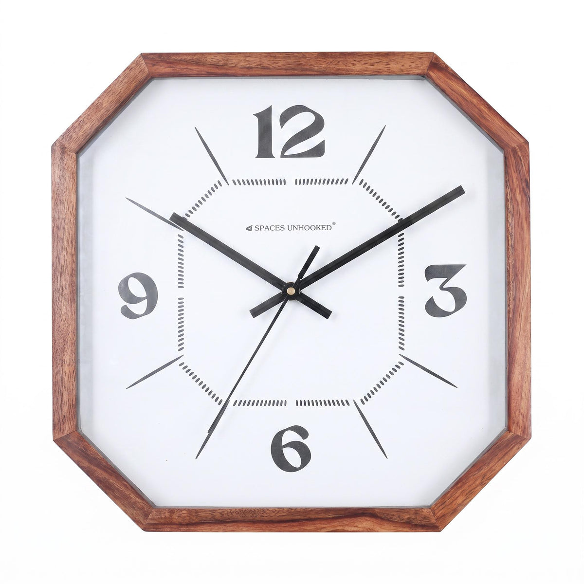 Cut-corner wall clock with minimal 12-3-6-9 dial hanging in a calm home office above a desk