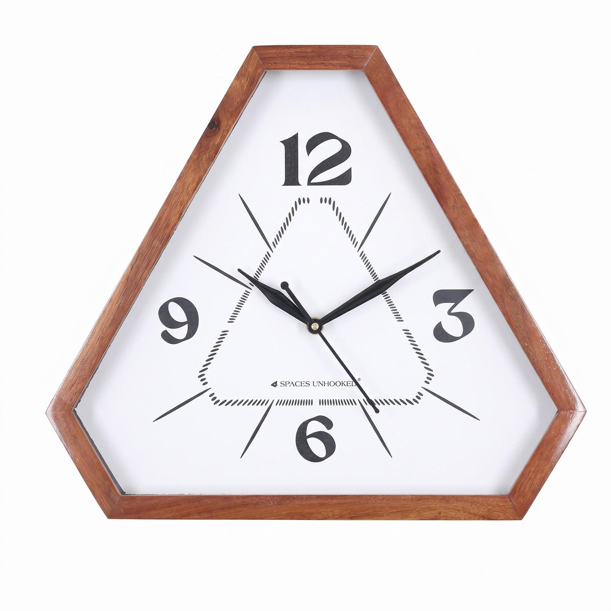 Triangle-shaped wall clock with minimal 12-3-6-9 dial hanging in a calm home office above a desk