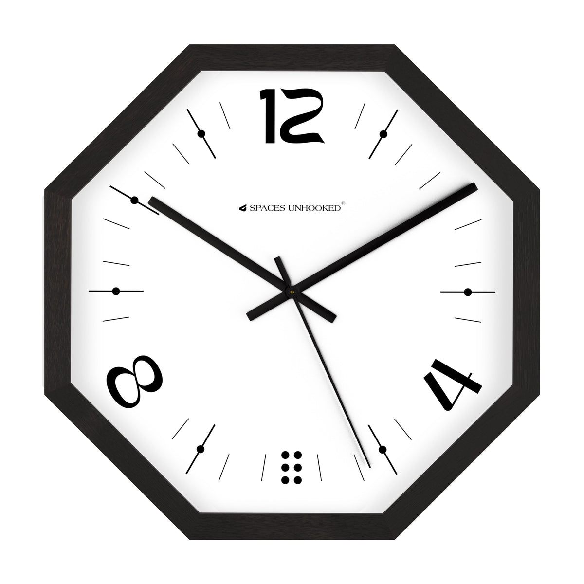 Black octagonal wall clock above a desk in a modern monochrome home office with plants
