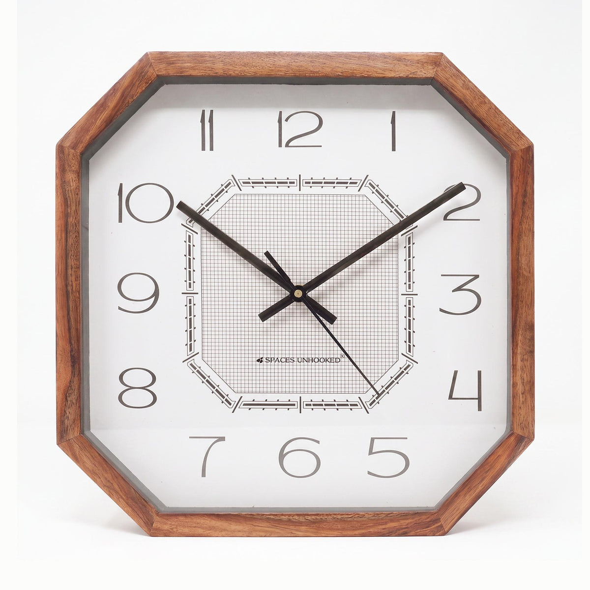 Octagonal grid dial wall clock styled with a geometric rug and cushions in a modern lounge