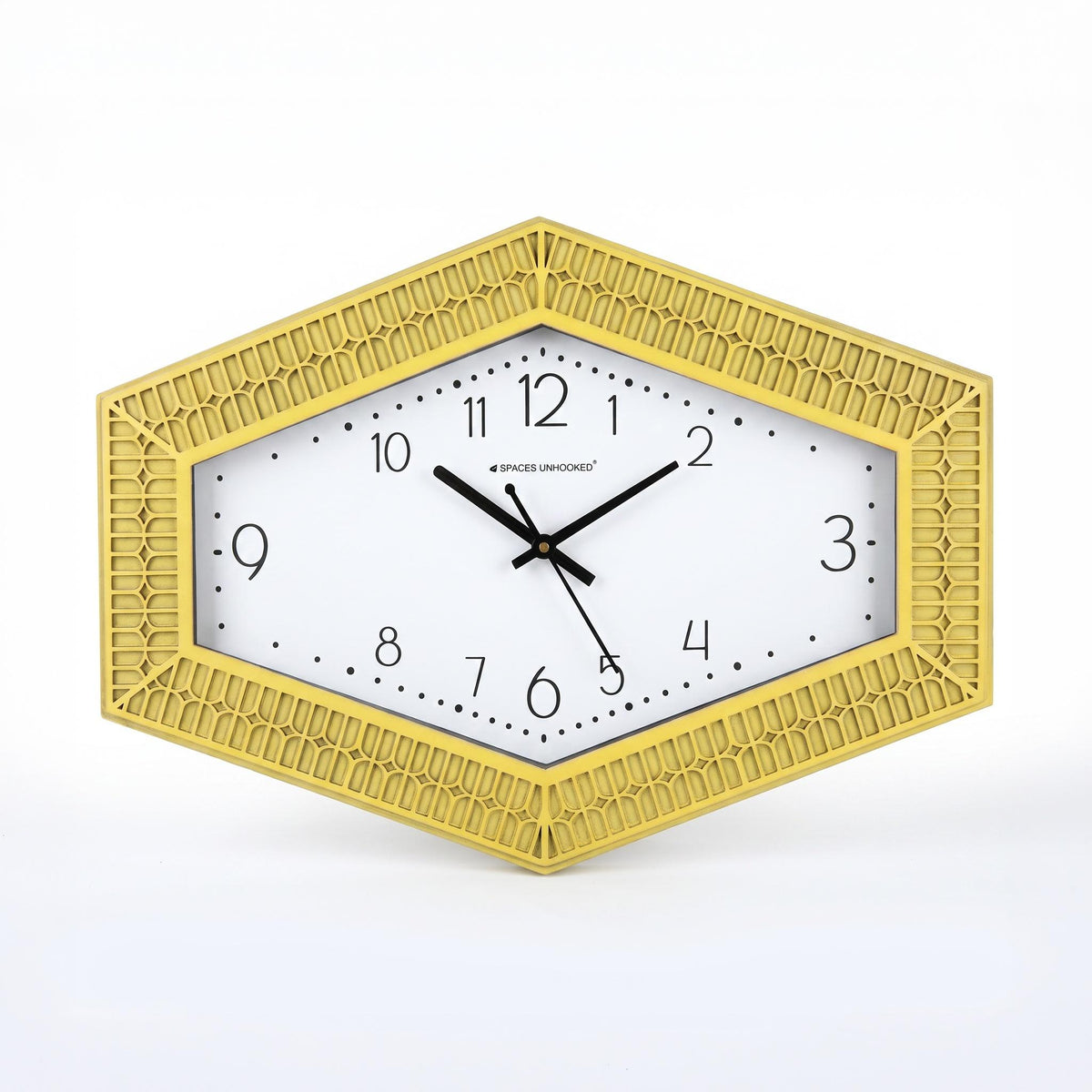 Hexagonal yellow wall clock on a living room wall above a sofa