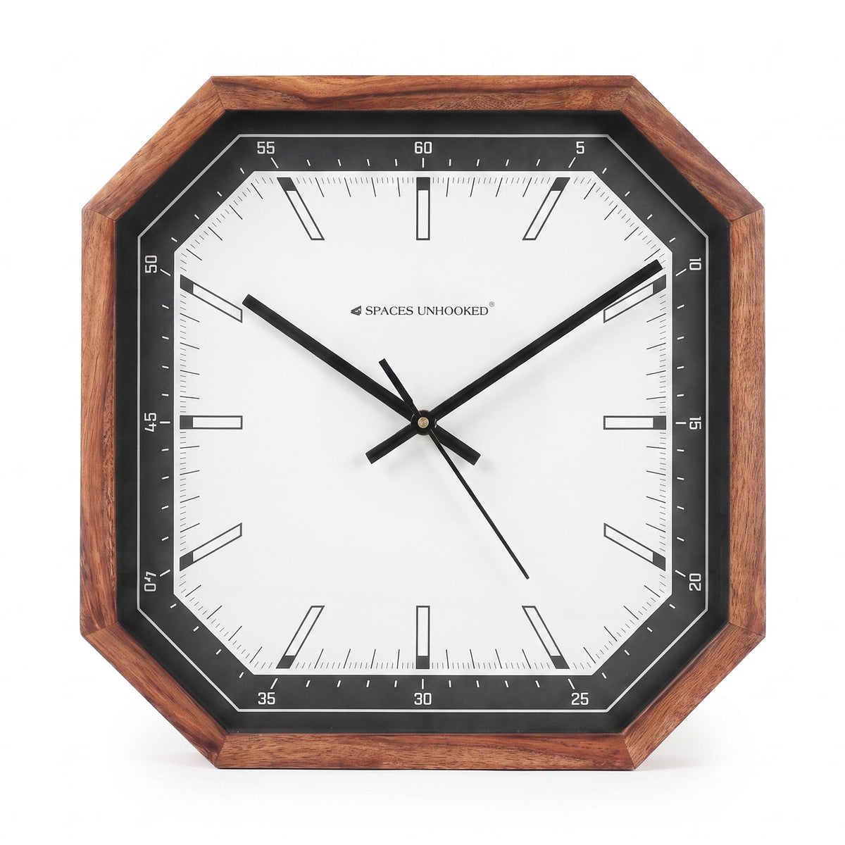 Modern octagonal wooden wall clock with black and white dial on a grey living room wall