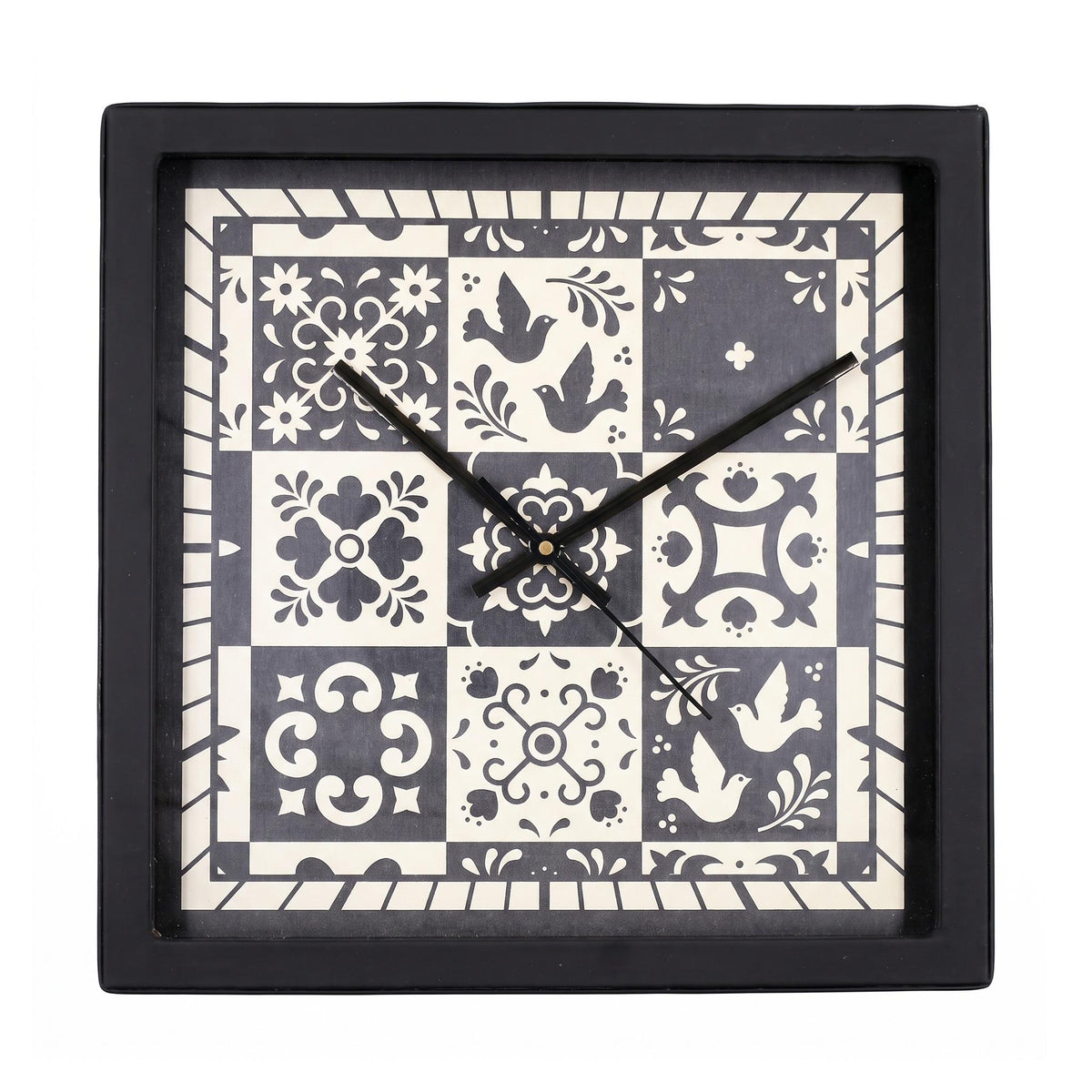 Folk art tile wall clock on a desk in a bright home office