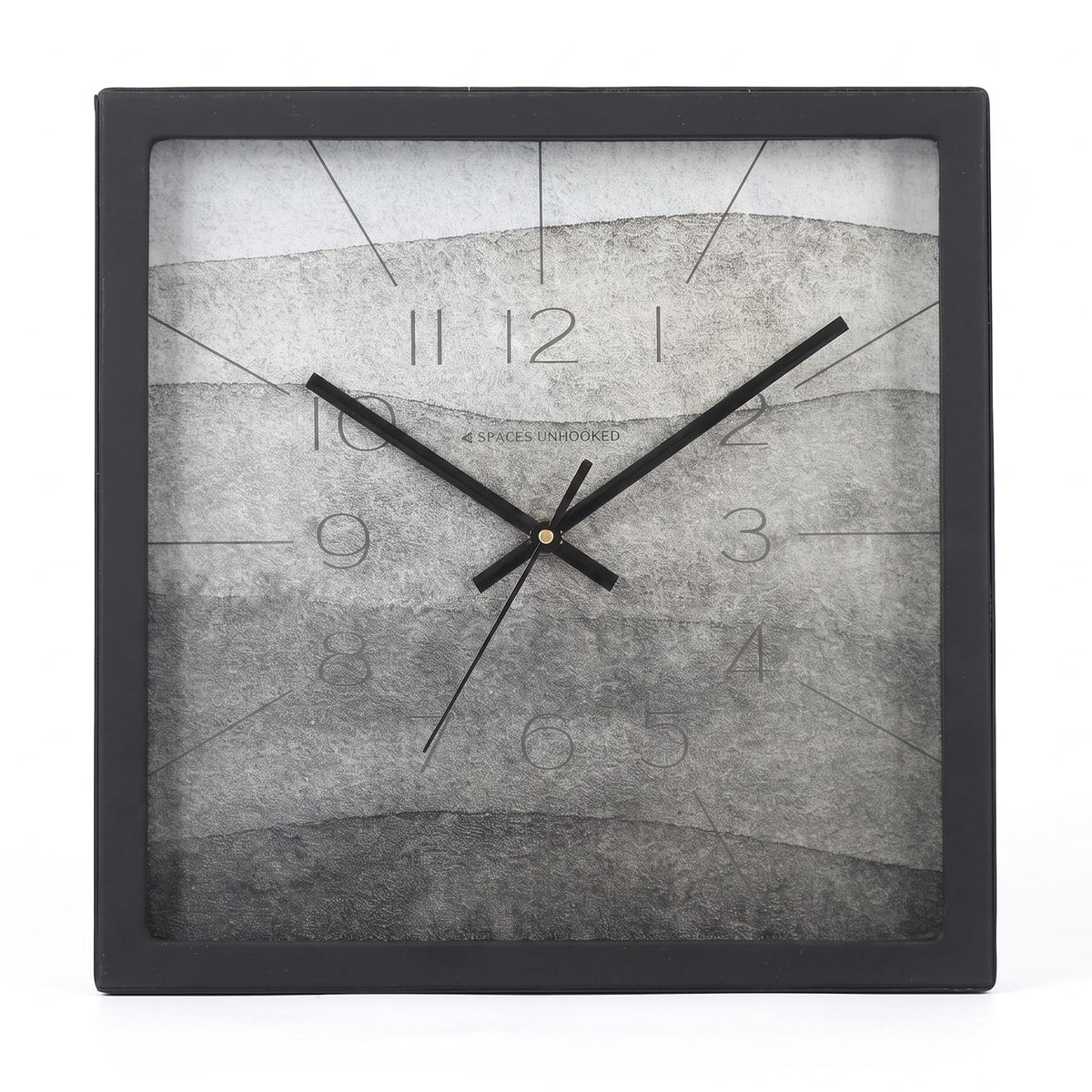 Ash grey watercolour wall clock on a home office wall above a desk