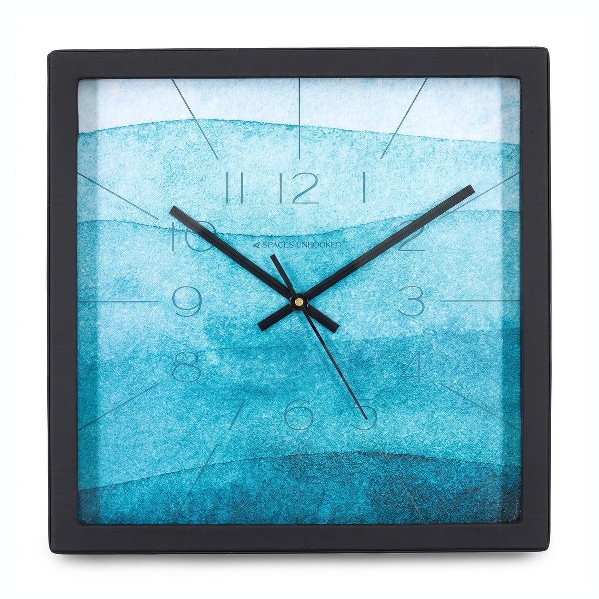 Teal watercolour wall clock on a study wall above a work desk