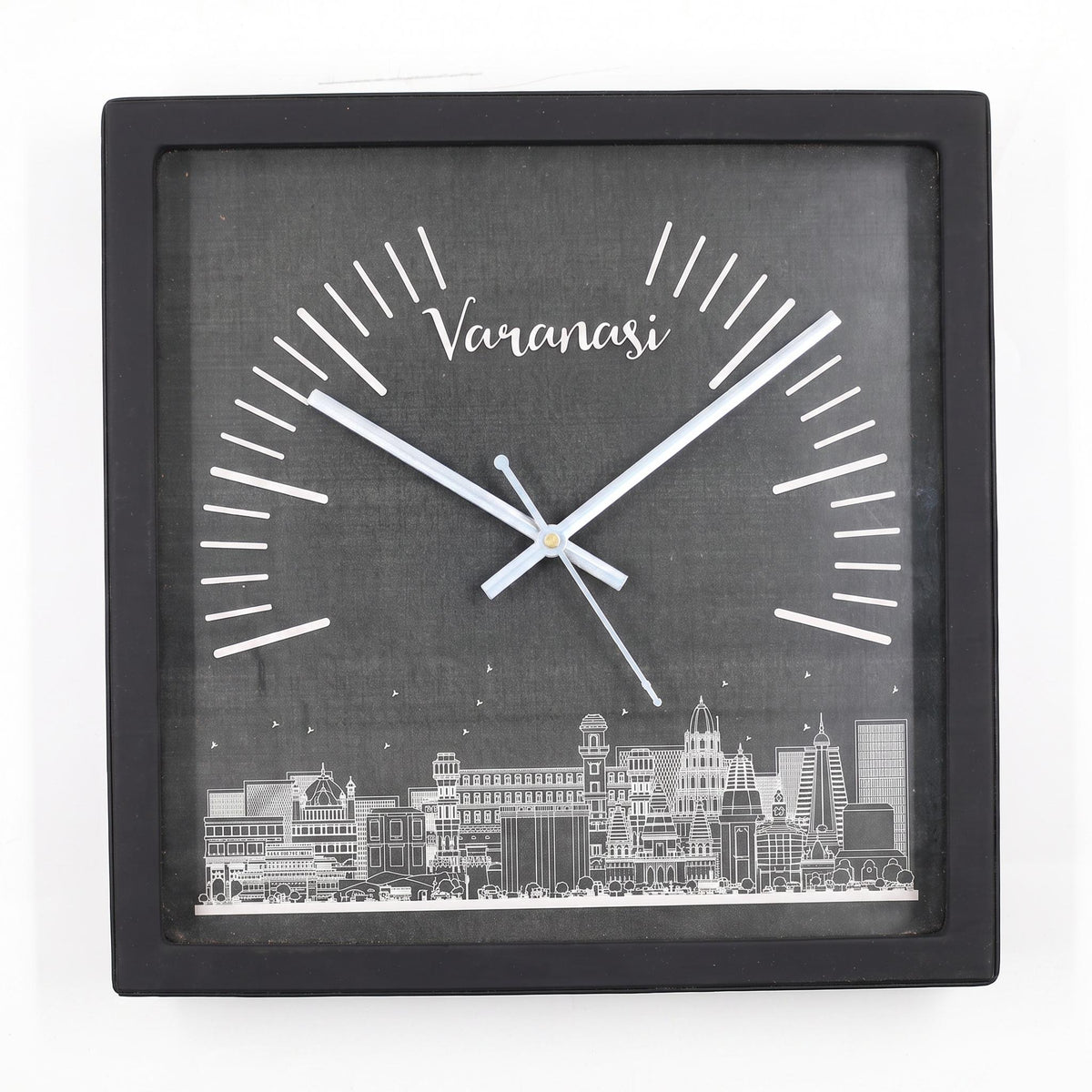 Varanasi skyline wall clock on a study wall above a bookshelf