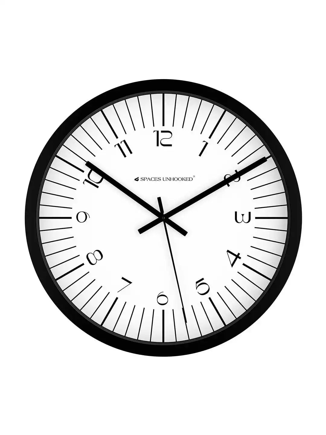 Front view of Spaces Unhooked black round wall clock with white dial on white background