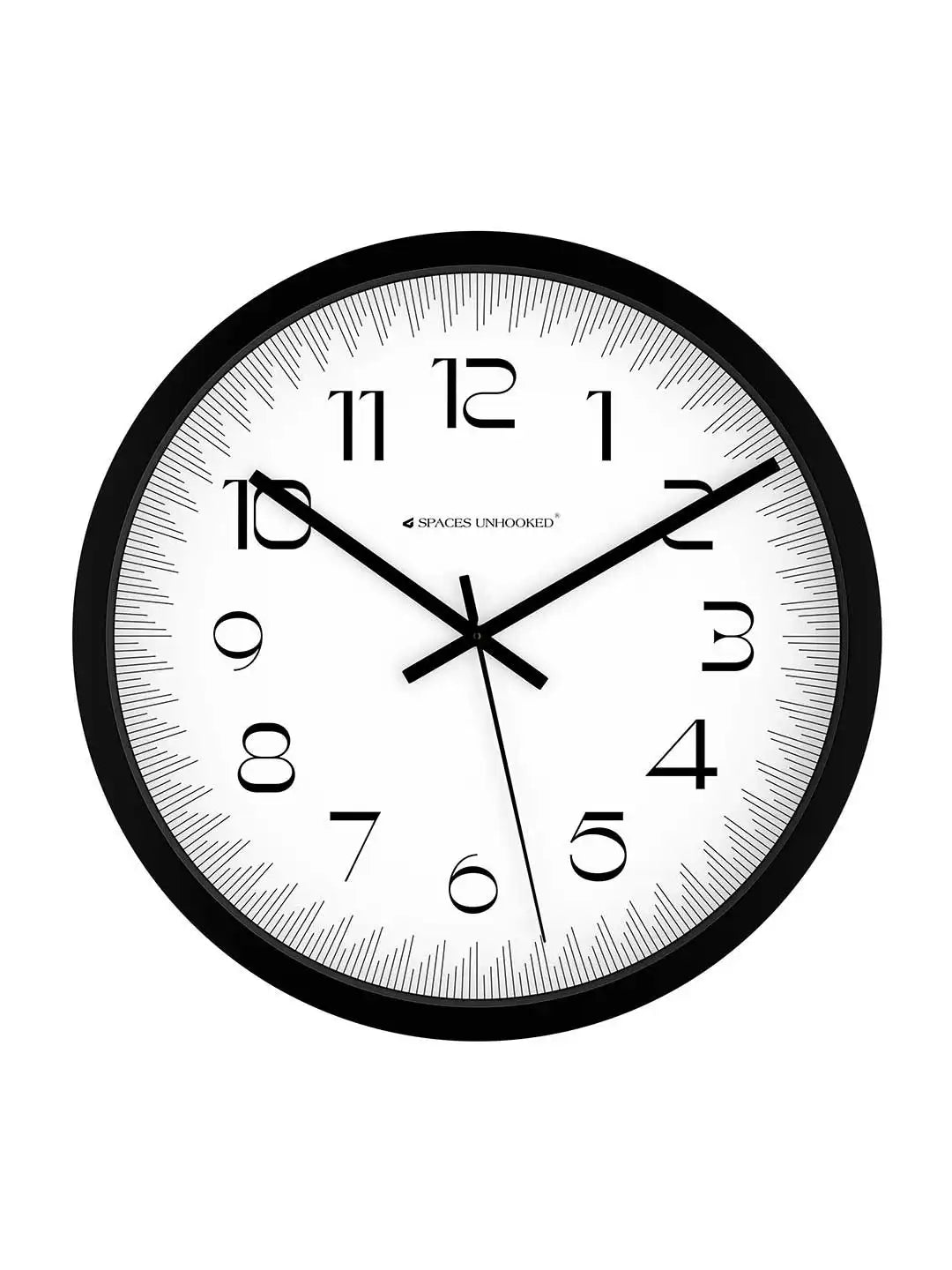 Front view of Spaces Unhooked black round wall clock with white dial on white background