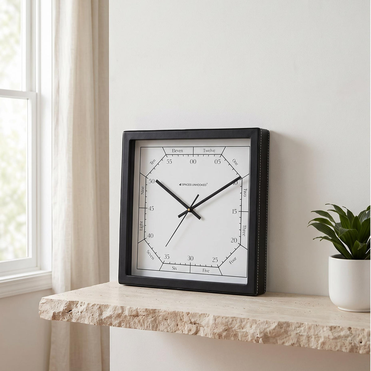 Square black wall clock with bold numerals and art deco stripes, front view
