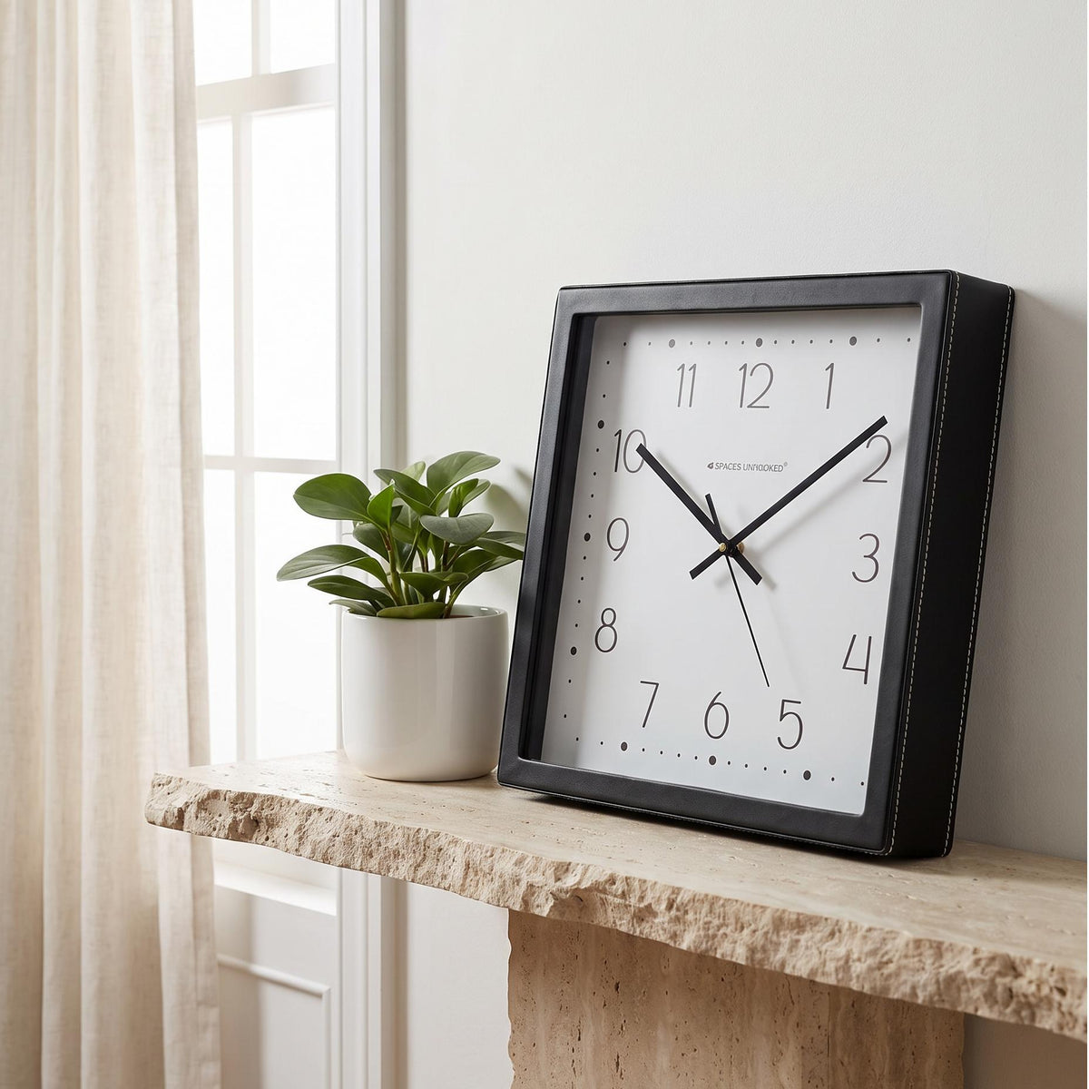 Square black wall clock with dotted border and slim numerals, front view