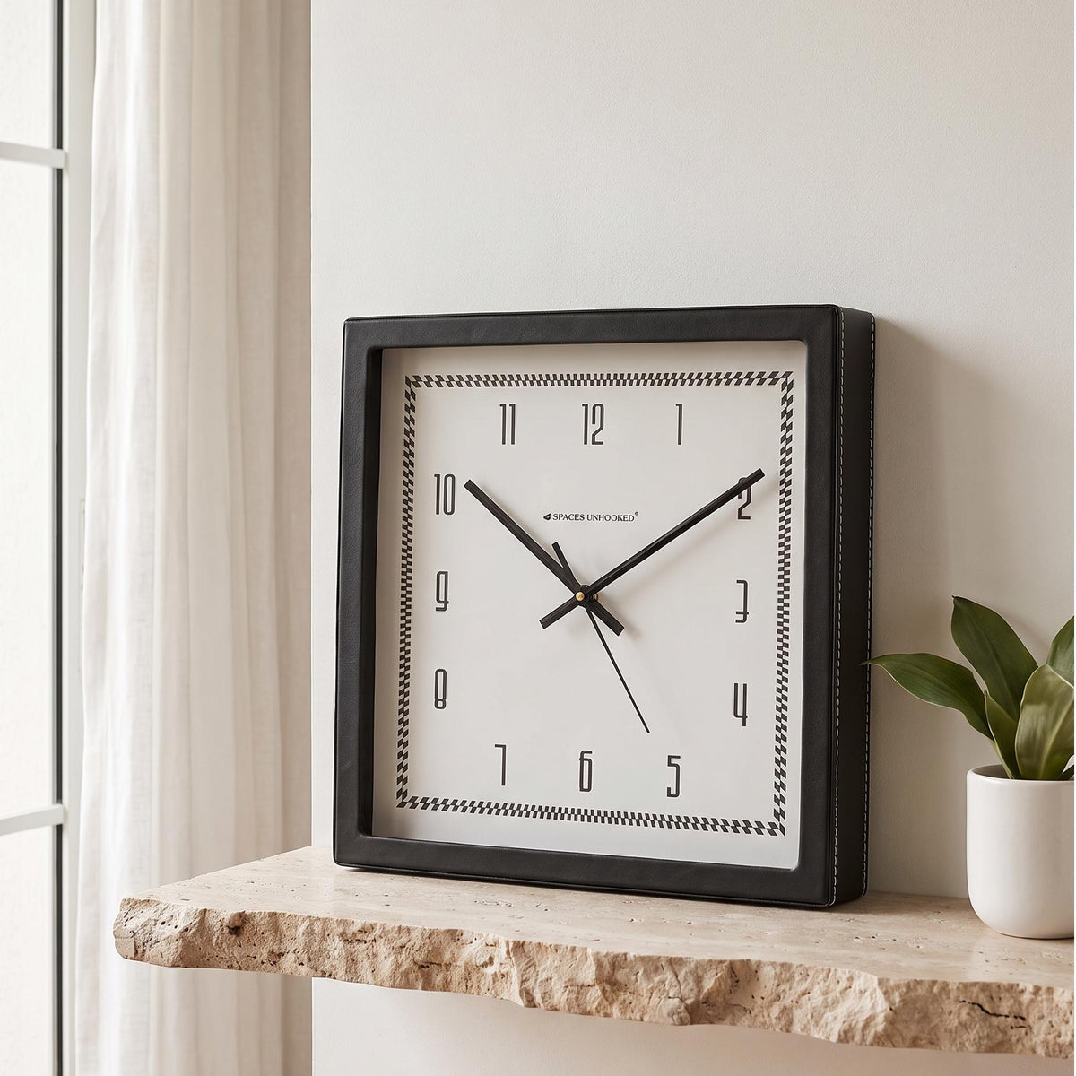 Square black wall clock with tall slim numerals and checked border, front view