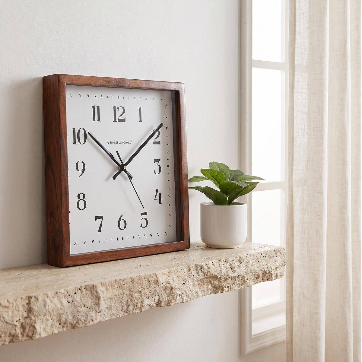 Spaces Unhooked square wooden wall clock with bold black numerals on a white dial, front view