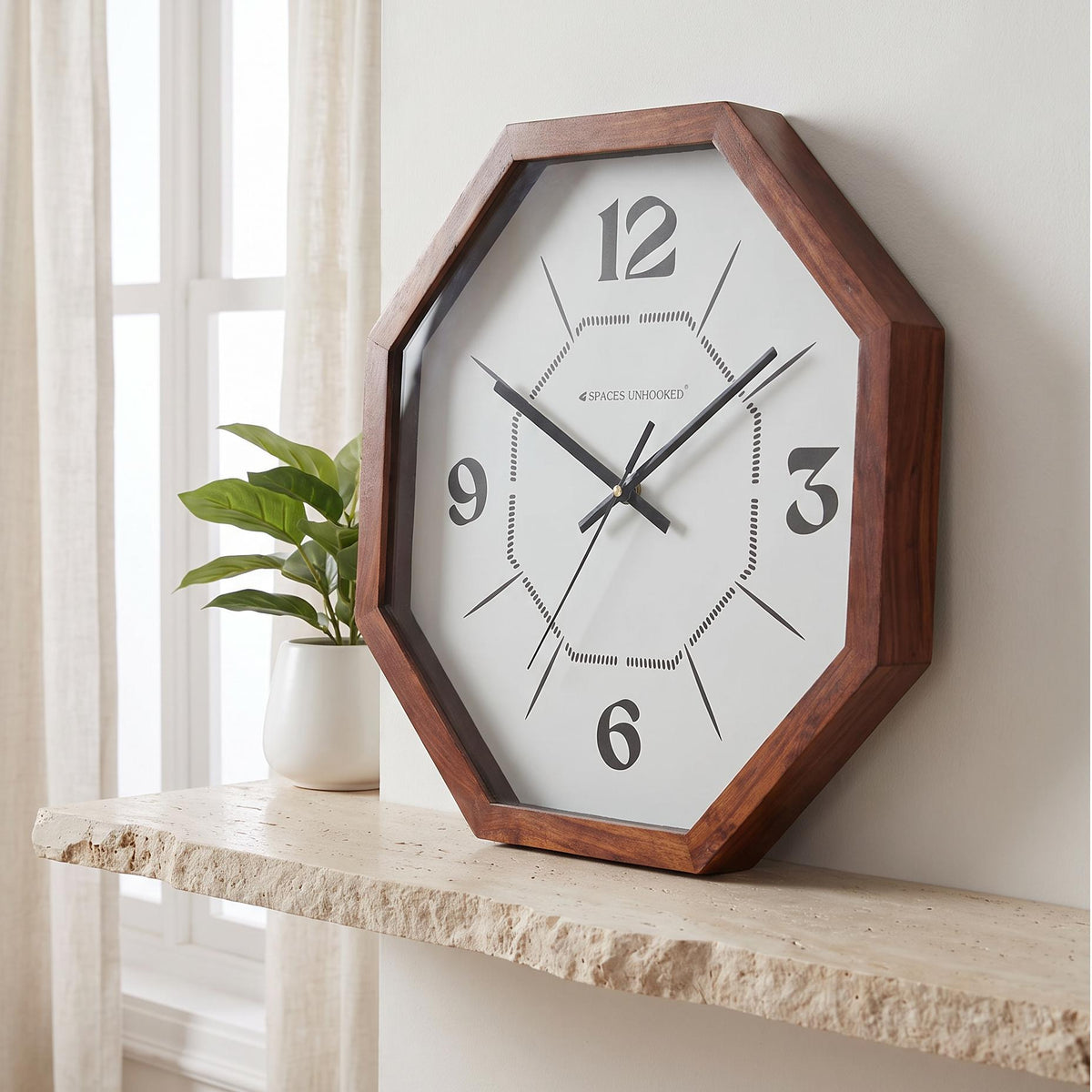 Spaces Unhooked octagonal wooden wall clock with dotted inner octagon dial, front view