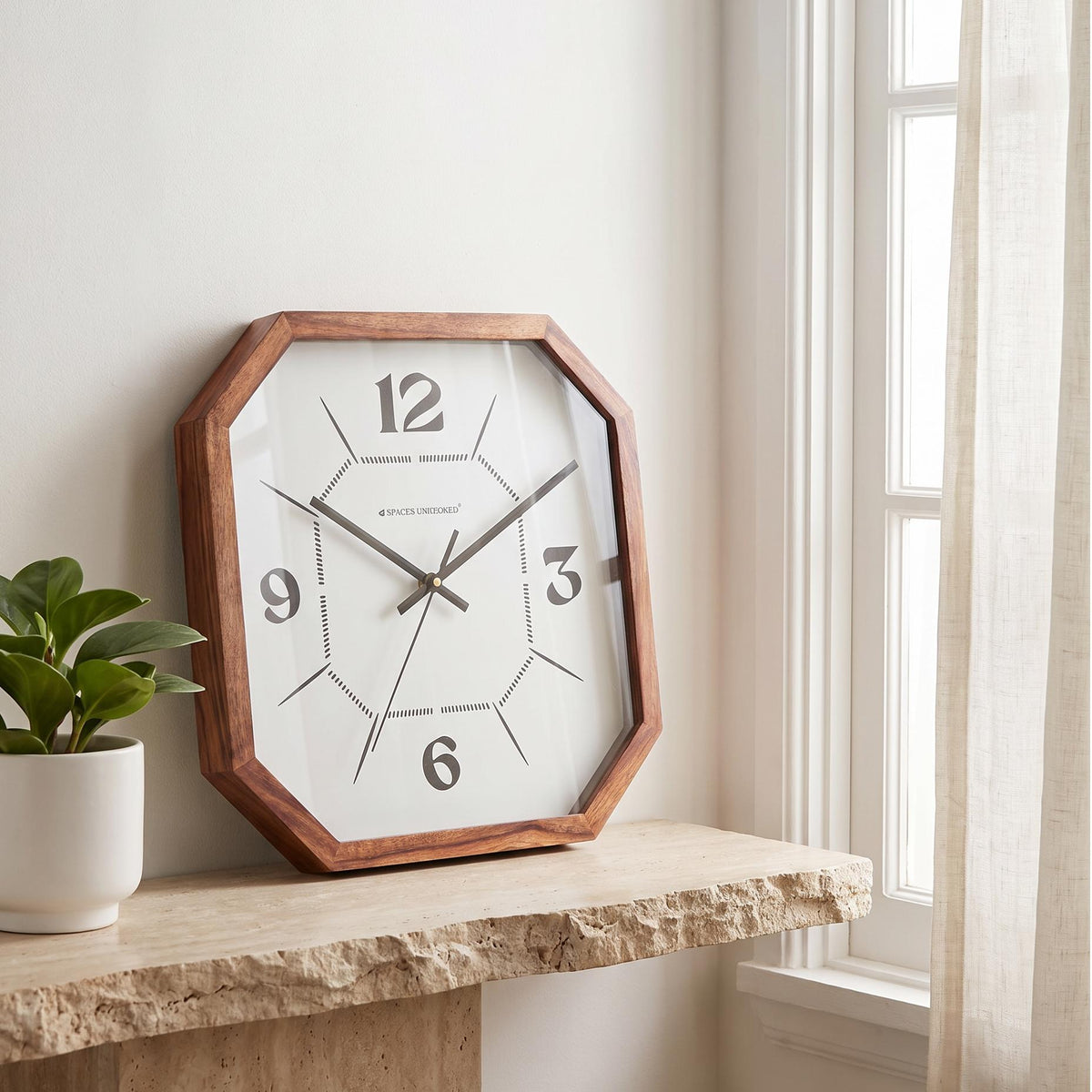 Spaces Unhooked octagonal wooden wall clock with dotted inner octagon dial, front view
