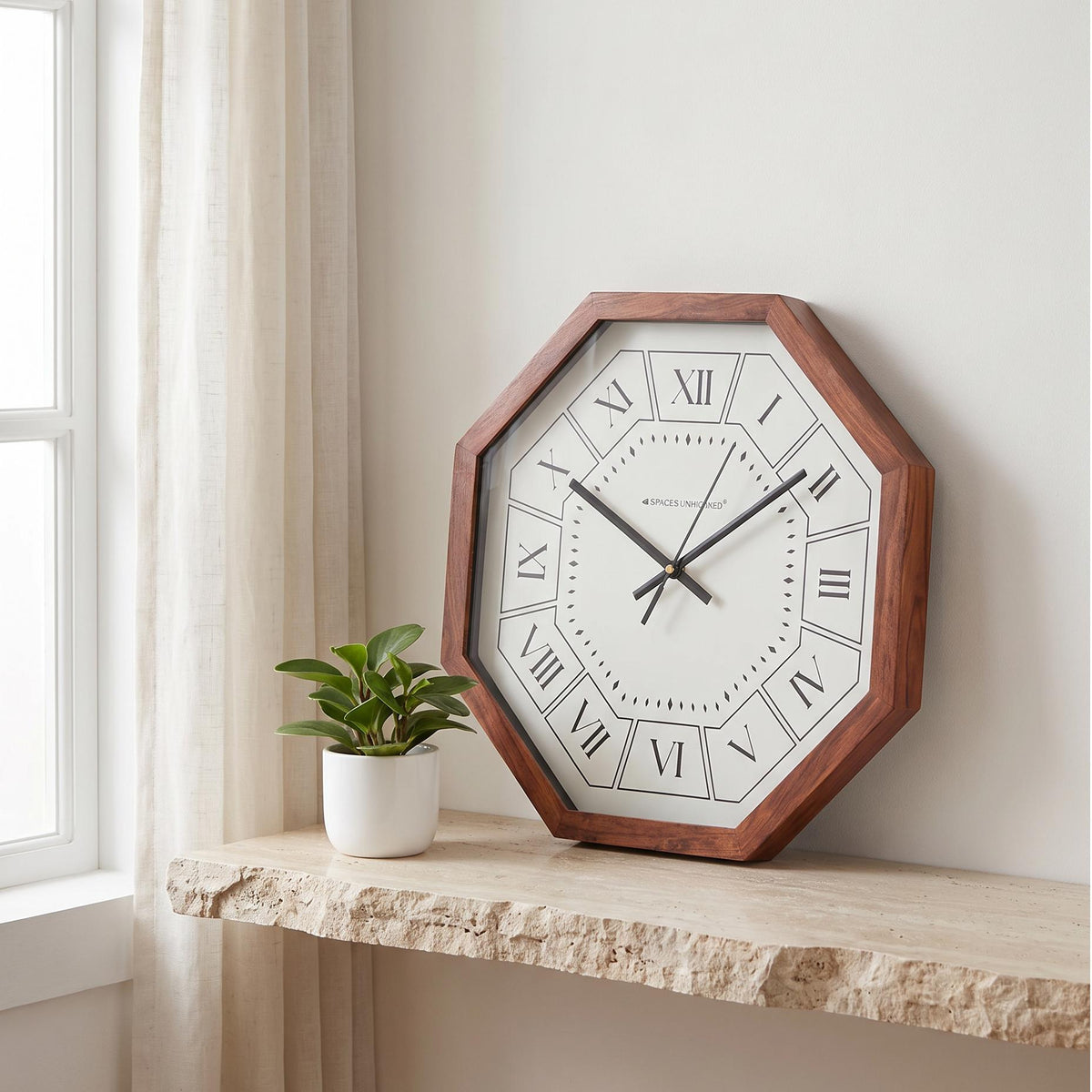 Spaces Unhooked Roman numeral octagonal wooden wall clock with white dial, front view