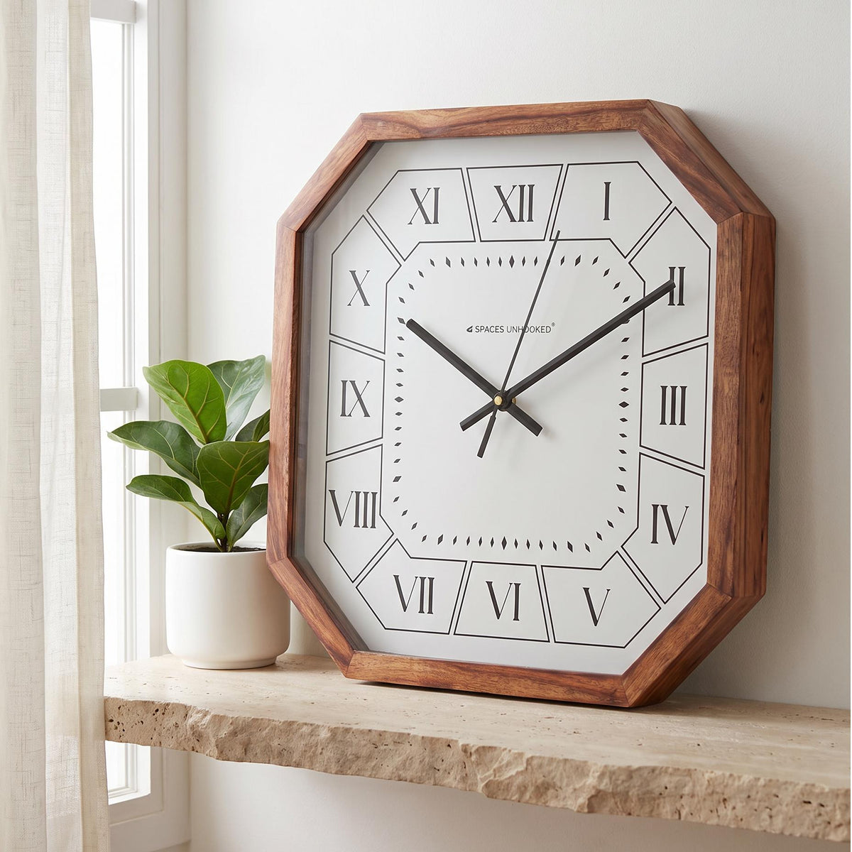 Spaces Unhooked Roman numeral octagonal wooden wall clock with white dial, front view