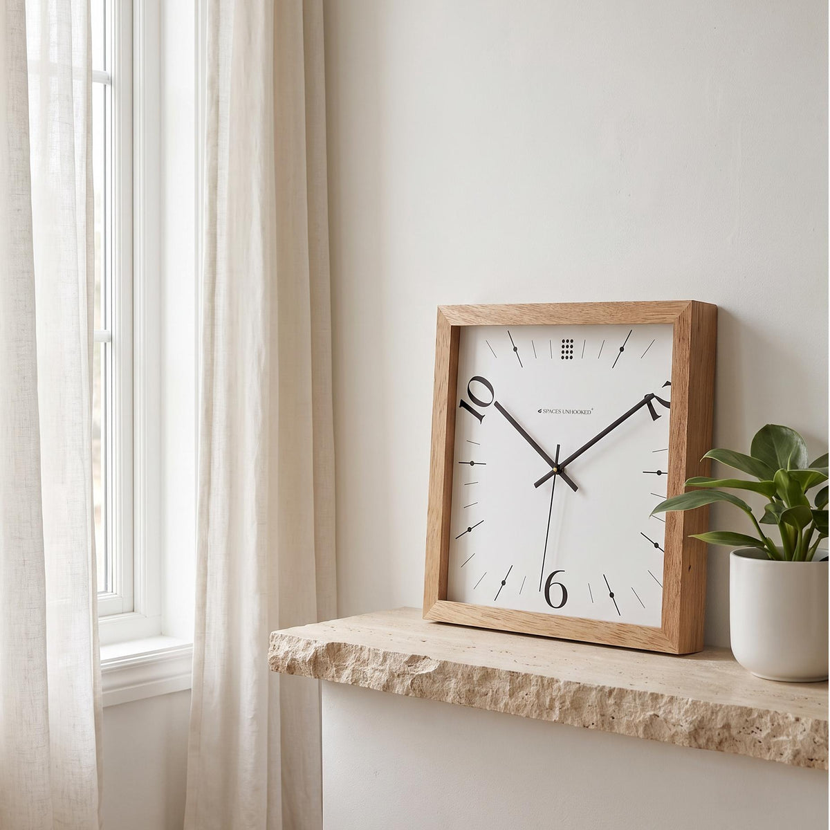 Spaces Unhooked light oak square wooden wall clock with 10, 2 and 6 numerals, front view