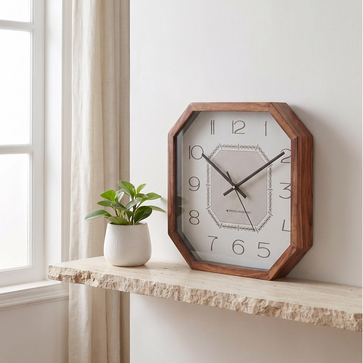 Spaces Unhooked art deco octagonal wooden wall clock with fine grid dial, front view