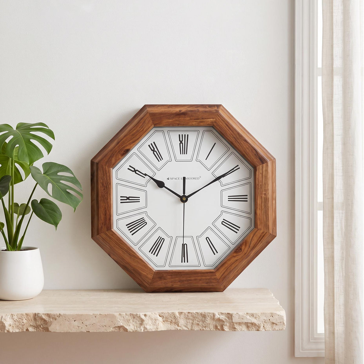 Octagonal wooden wall clock with Roman numerals in outlined cells on a white dial